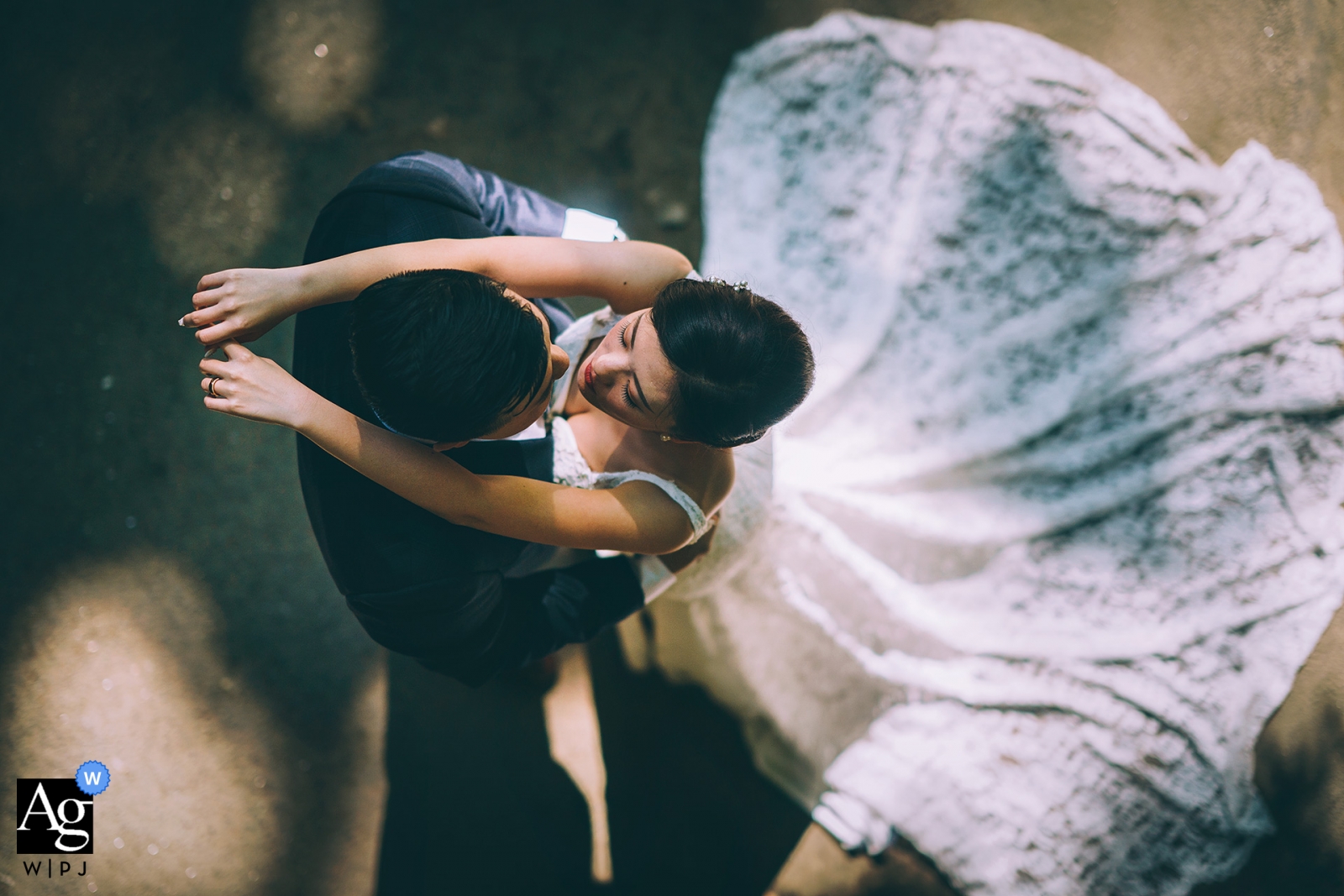 An overhead camera view of a New York City bride and groom posing for a wedding day portrait