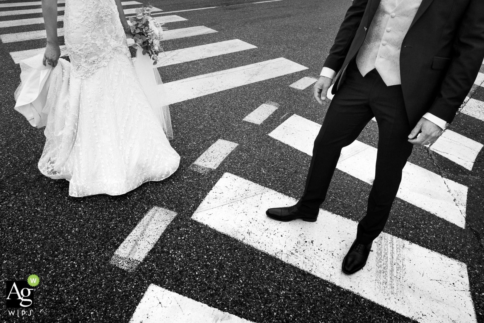 Photo by: <a href="https://www.wpja.com/photos/artistic-wedding-photographers-details/2302991">Sylvain Bouzat - Lyon French wedding photographer in Annecy Alps - Bride and Groom detail in roadway crosswalks