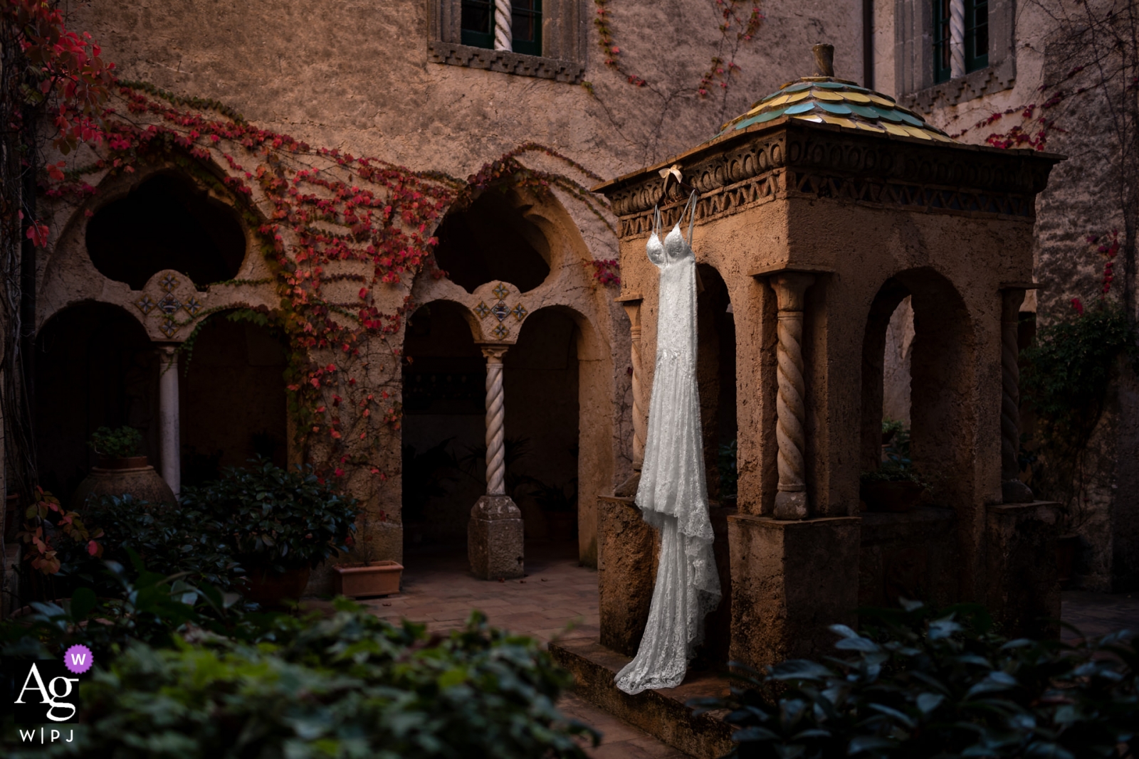 The bride's dress was elegantly displayed on an old world building, hanging gracefully from beautiful architecture