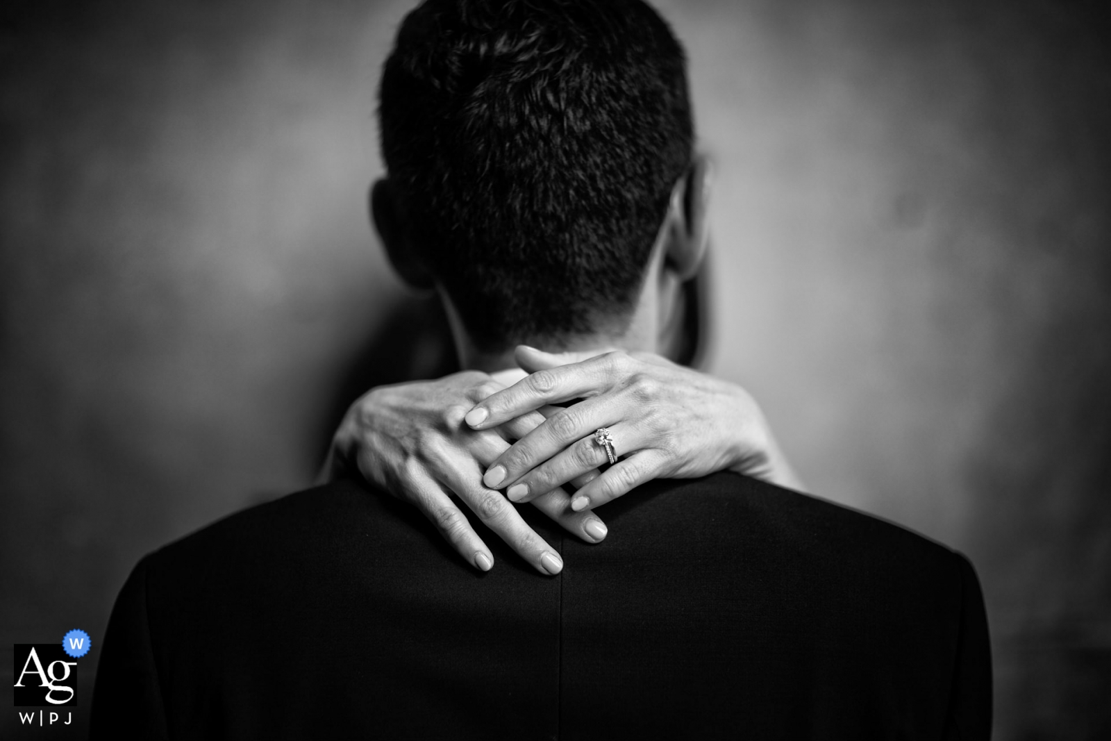Photo by: <a href="https://www.wpja.com/photos/artistic-wedding-photographers-details/2309311">Damiano Salvadori - Certaldo Firenze Florence artistic wedding photography details | bride's hands with ring on groom's neck/suit.