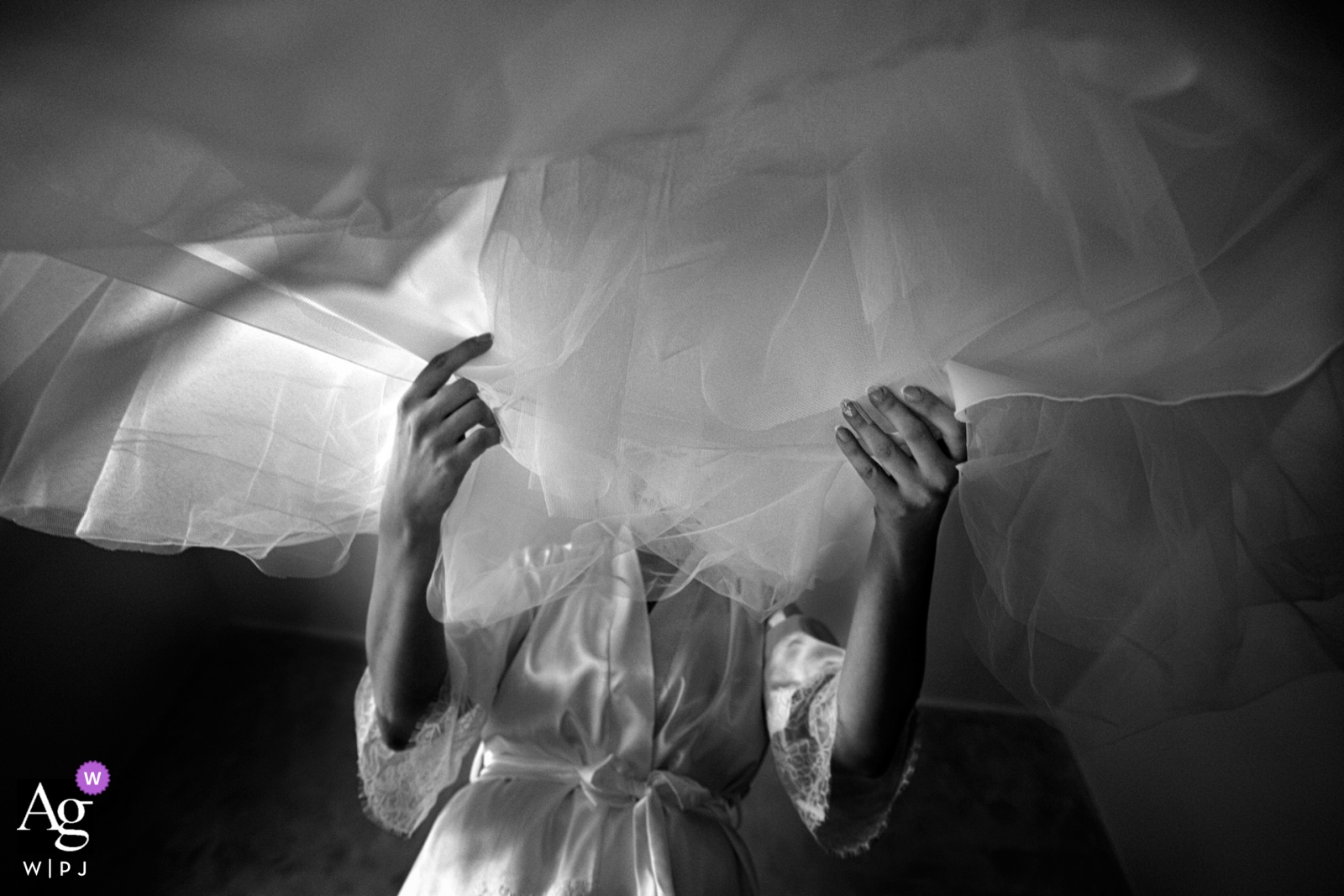 Calabria bride inspecting her wedding gown in this BW image