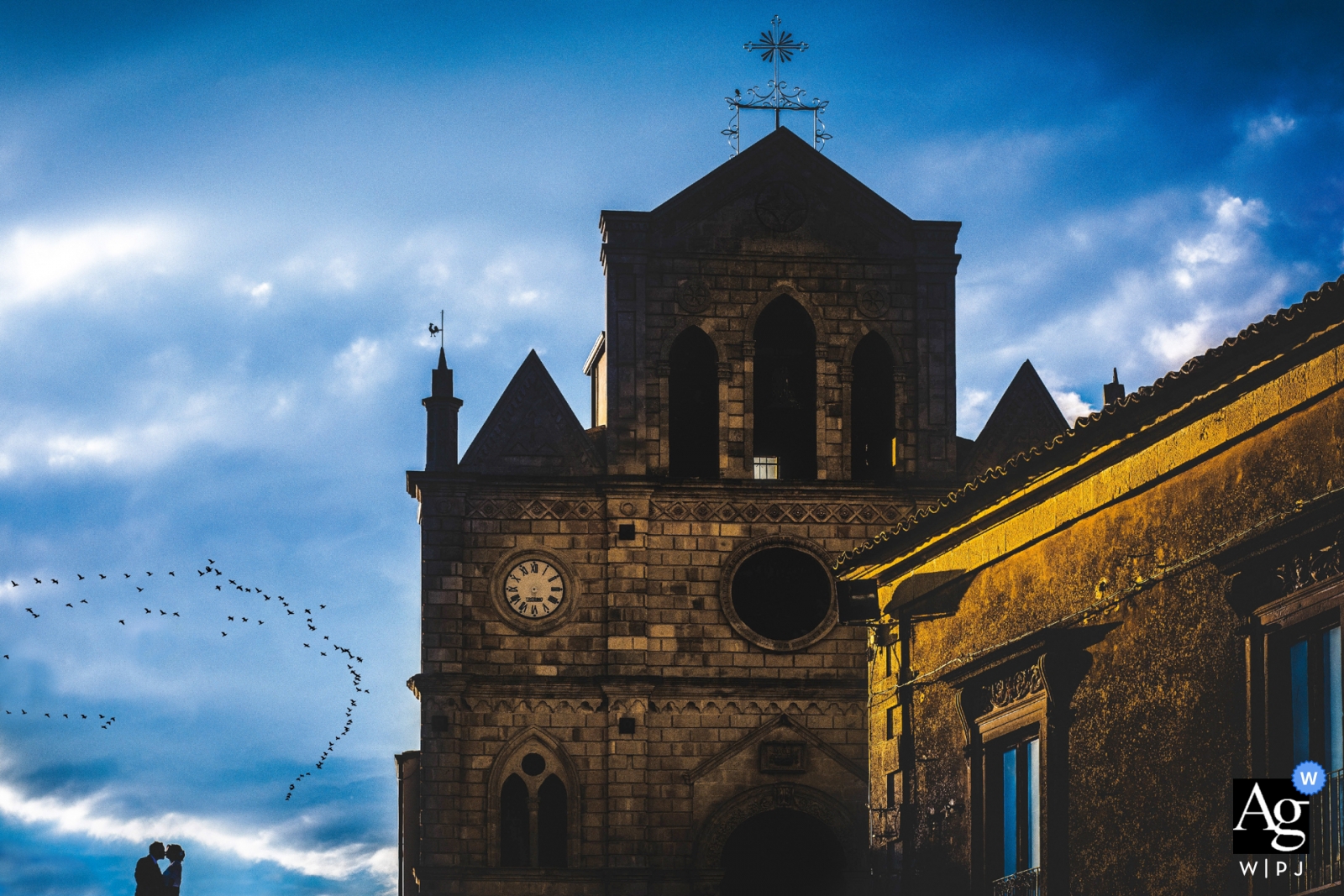 Photo by: <a href="https://www.wpja.com/photos/artistic-wedding-photographers/2433806">Simona Cancelli - Siracusa Siracusa Monterosso Almo wedding photography | Spring portrait of the bride and groom silhouetted against the sky in Sicily