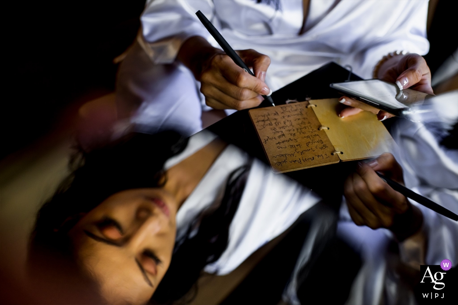 A wedding took place at Ho Coc, Ho Chi Minh, Vietnam, accompanied by the loving ritual of the bride hand writing her vows, captured with a reflection