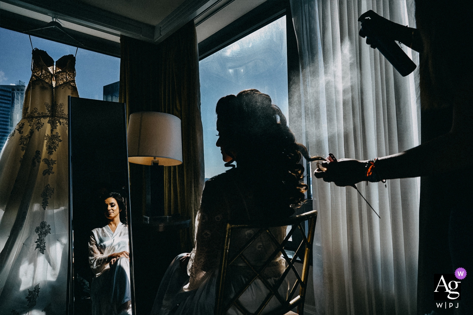 Photo by: <a href="https://www.wpja.com/photos/artistic-wedding-photographers/2440221">Emin Kuliyev - Bronx New York Wedding photographer for Battery Gardens, New York | the bride getting ready with curls and hair spray applied