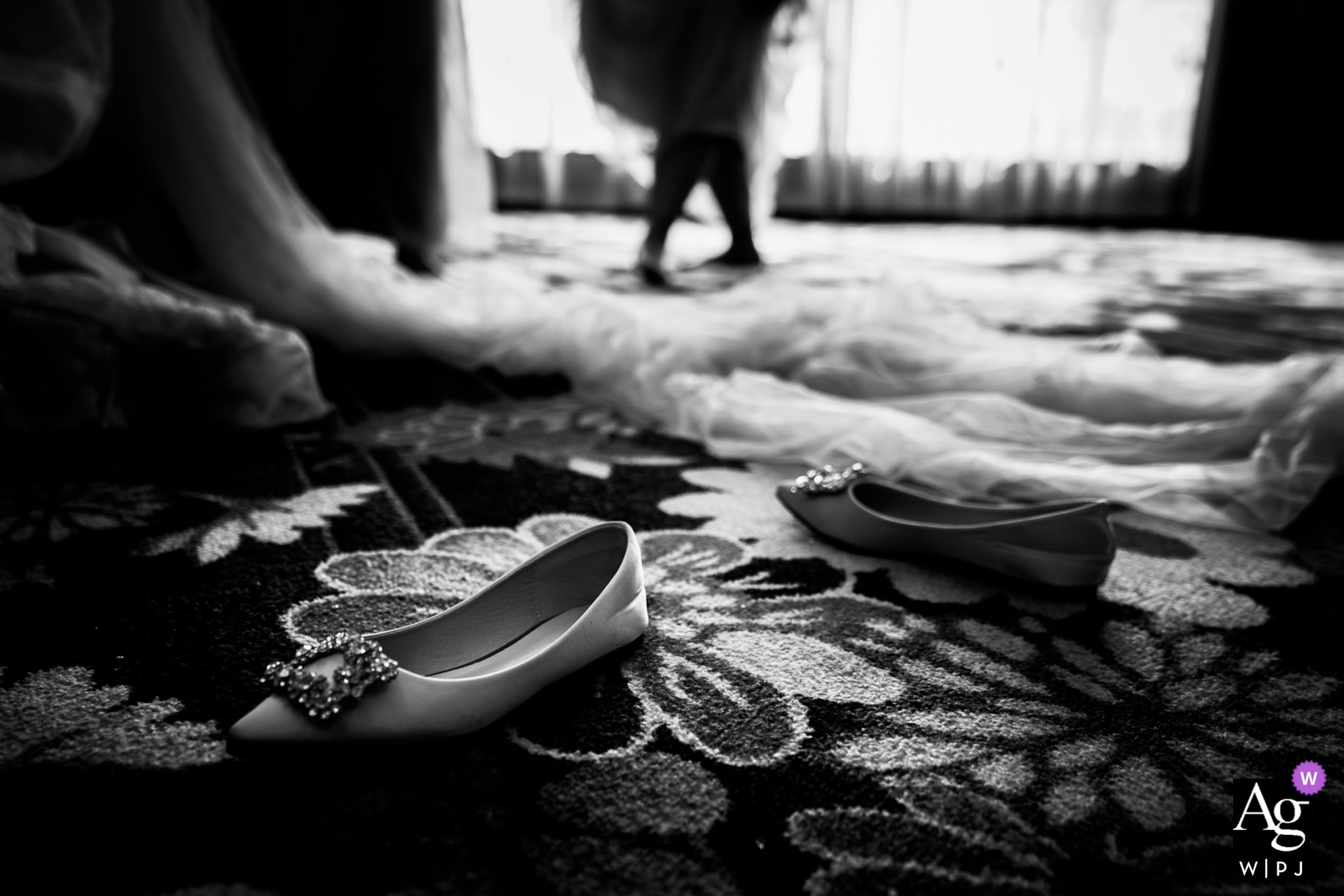 Photo by: <a href="https://www.wpja.com/photos/artistic-wedding-photographers/2450121">Vinci Wang - FuZhou China wedding photography | The shoes of the bride on the hotel carpet with the dress - getting ready for the wedding ceremony