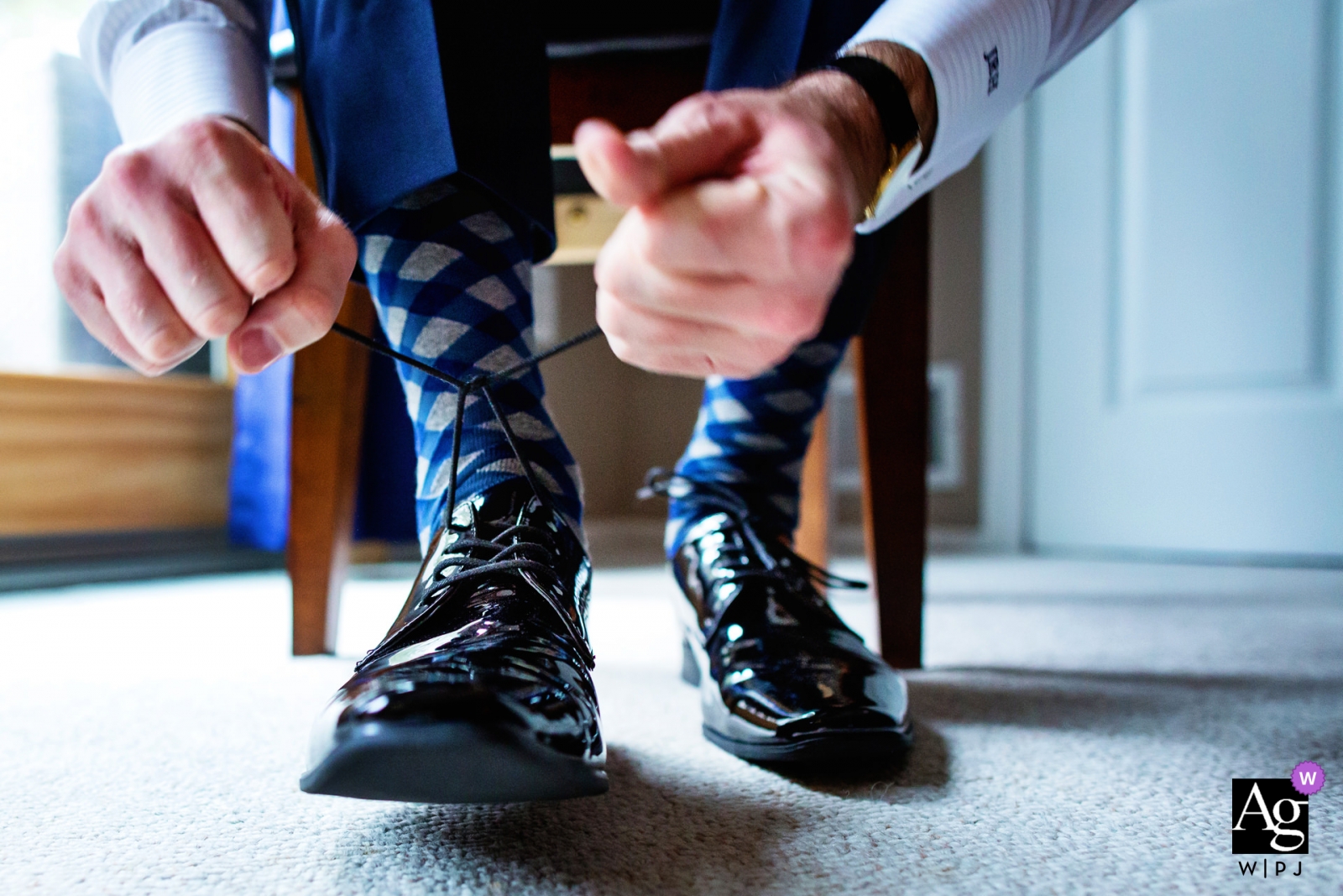 Photo by: <a href="https://www.wpja.com/photos/artistic-wedding-photographers/2452451">Michelle Arlotta - Milford New Jersey Ryland Inn NJ Weddings | photograph of the groom tying his shoes