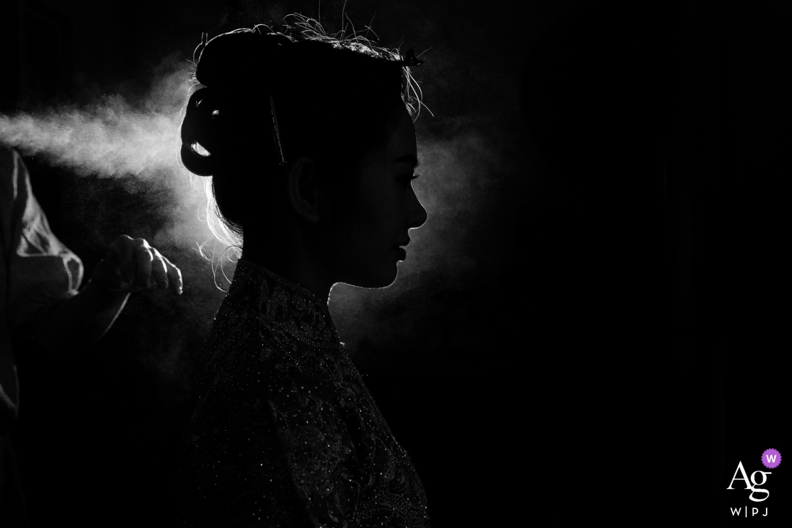 Photo by: <a href="https://www.wpja.com/photos/artistic-wedding-photographers/2453616">Joy Qin - Longyan Fujian, China actual day wedding photography | Wedding Day Details of the bride with hairspray backlit