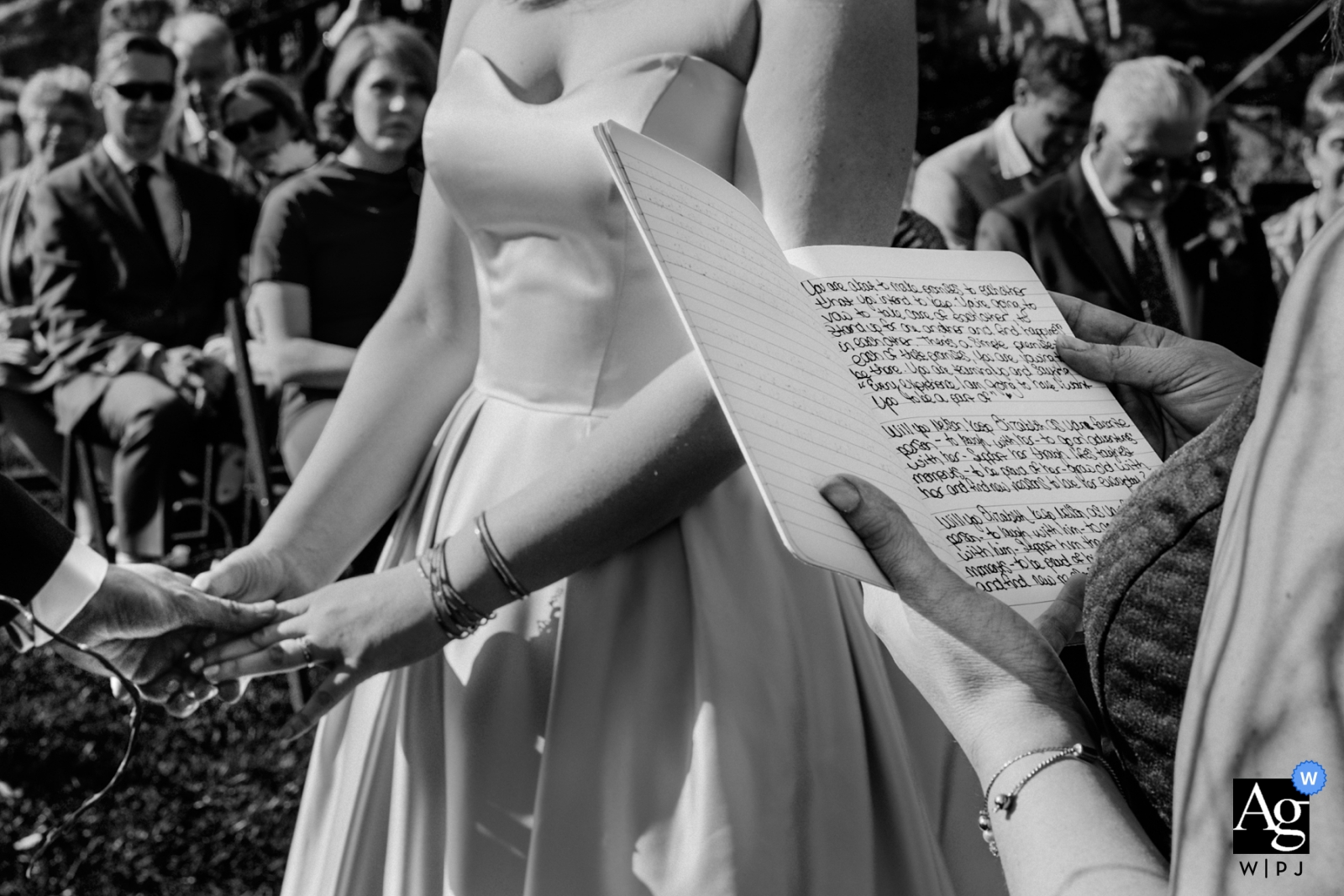 A black and white photograph of a bride and groom holding hands and highlighting Heretat de Guardia's ceremony captures the beauty of the special day