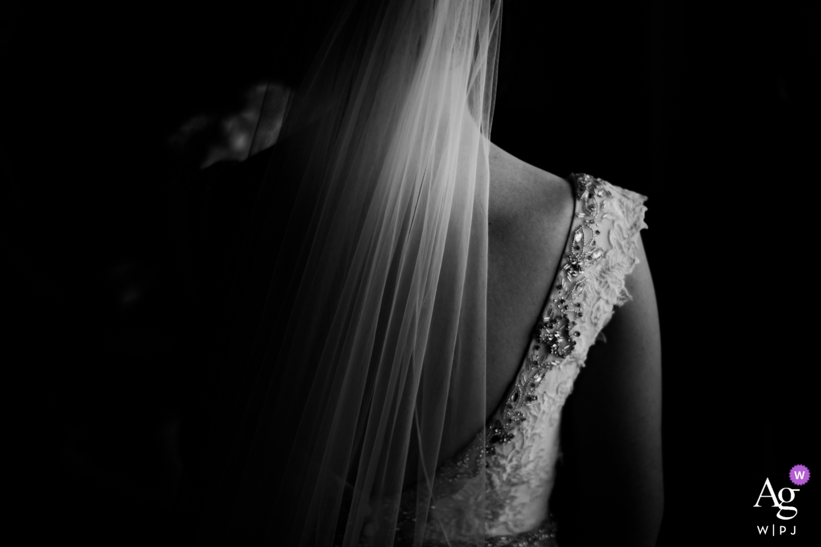 At Portmarnock Hotel Dublin, Ireland, a photo of the back of the bride is taken, illuminated in soft light