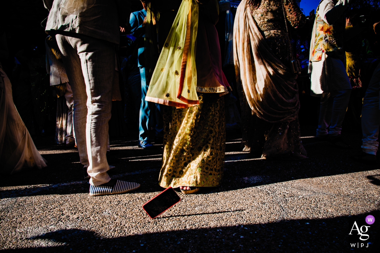 Photo by: <a href="https://www.wpja.com/photos/artistic-wedding-photographers/2470401">Thai Le - Ho Chi Minh Vietnam wedding photographer caught this photo of a phone hitting the pavement as the wedding guests walked to the ceremony - PHUQUOC WPJA