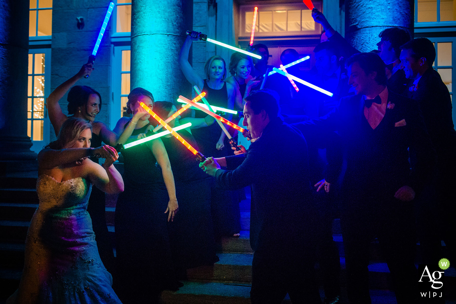 The Ballroom at Ellis Preserve wedding venue photos | Jedi bridal party battling with light sabers at night outside.