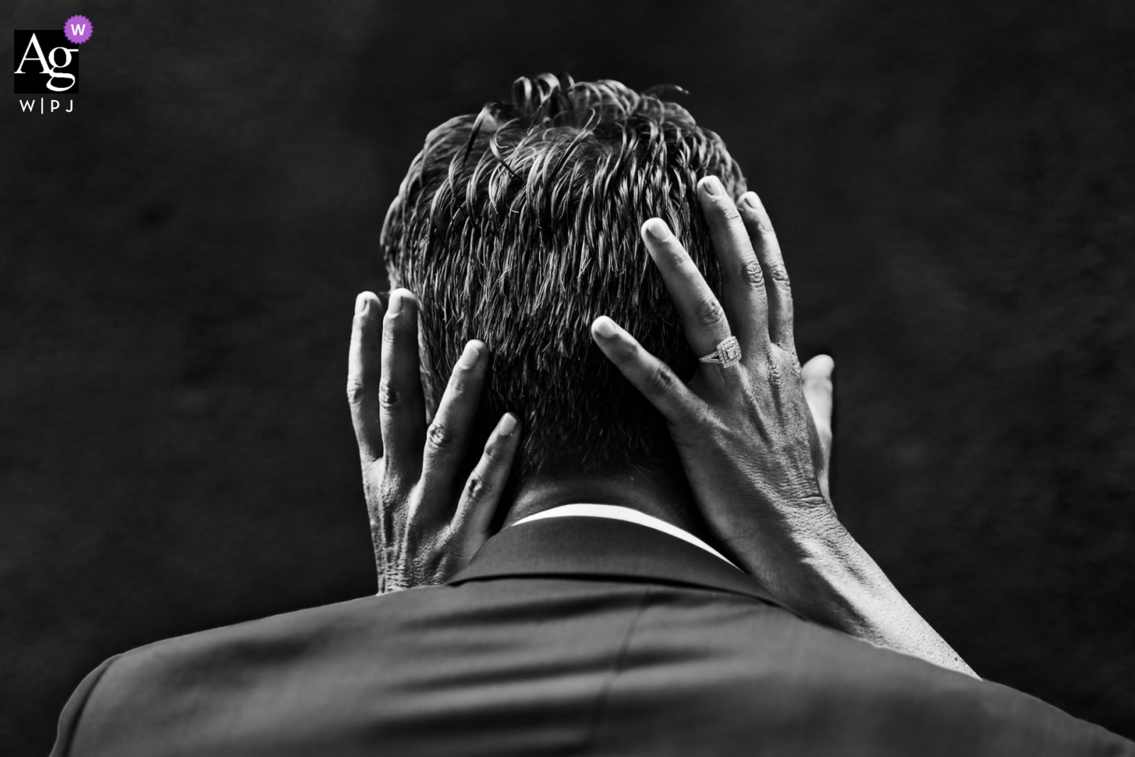 This wedding image taken by a photographer in Brittany, shows a detailed close-up of the Bride's hands on the Groom's head with the wedding ring