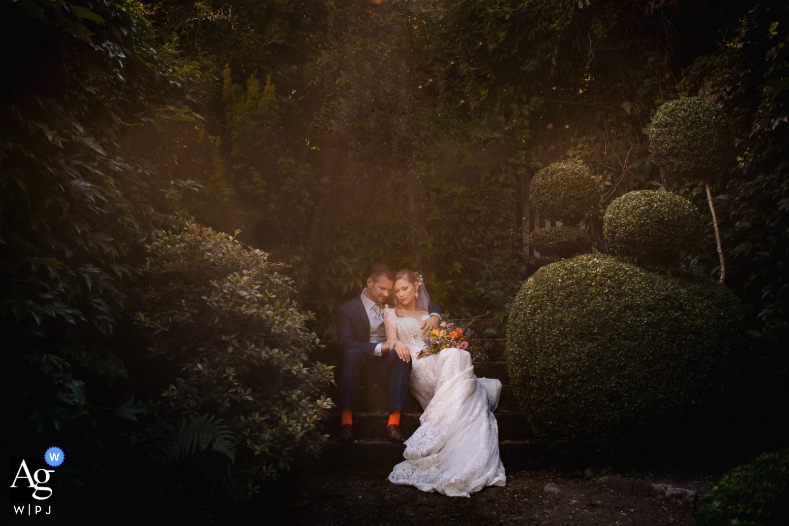 The bride and groom looked like a fairytale image as they sat in the garden of Schloss Eberstein on their wedding day