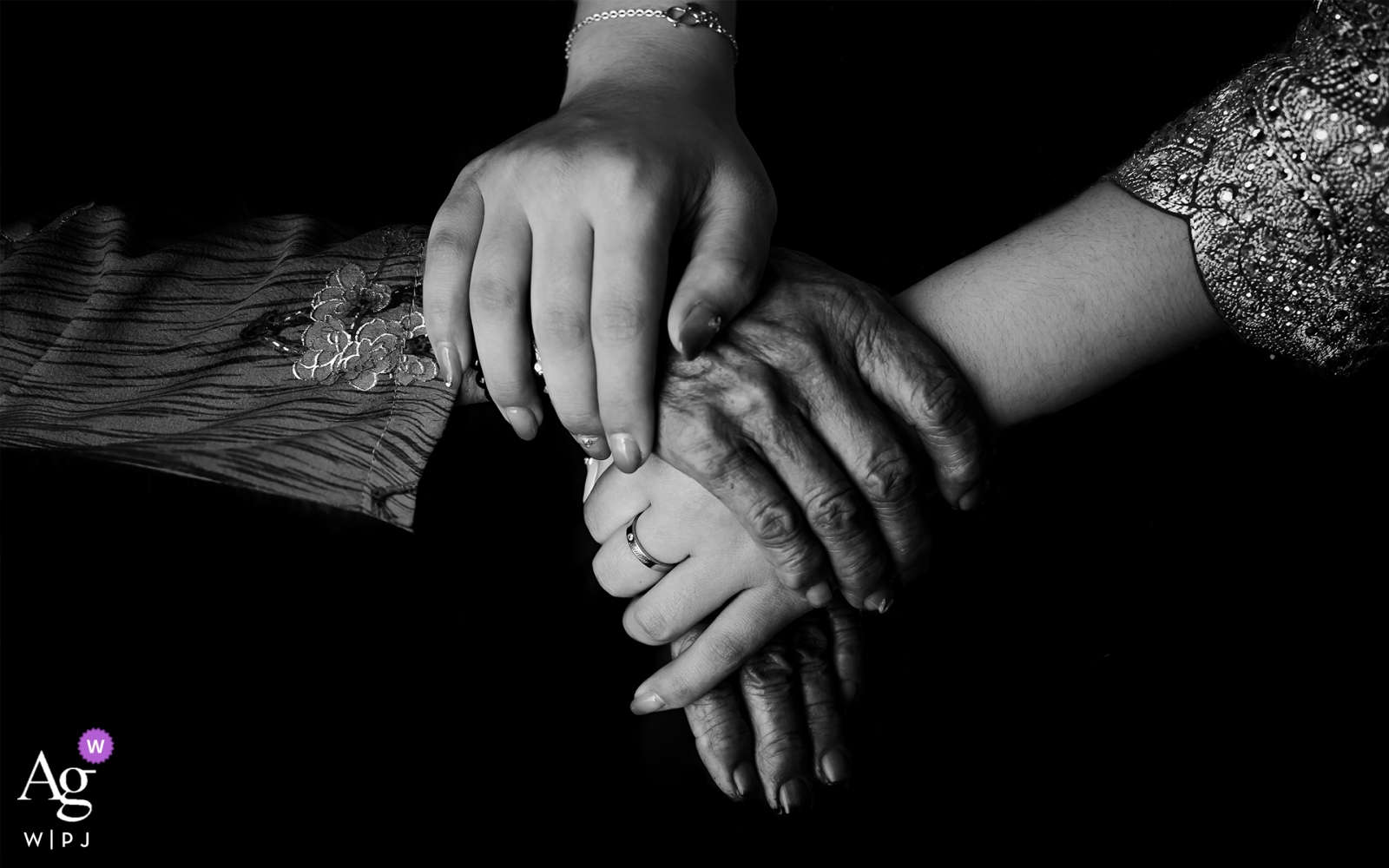 The bride's grandmother tenderly took her hand in the bride's living room, creating a special moment between them