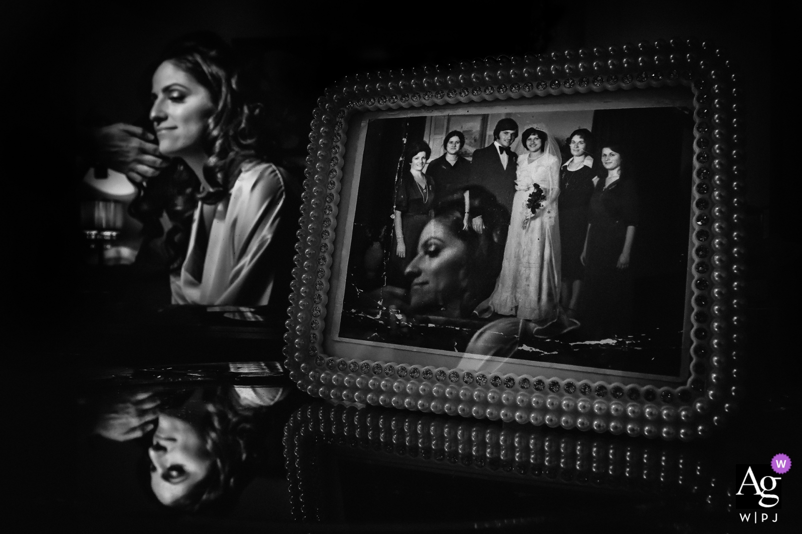 The bride prepared for her wedding in Kalymnos, Greece, with a beautiful family wedding portrait framed next to her