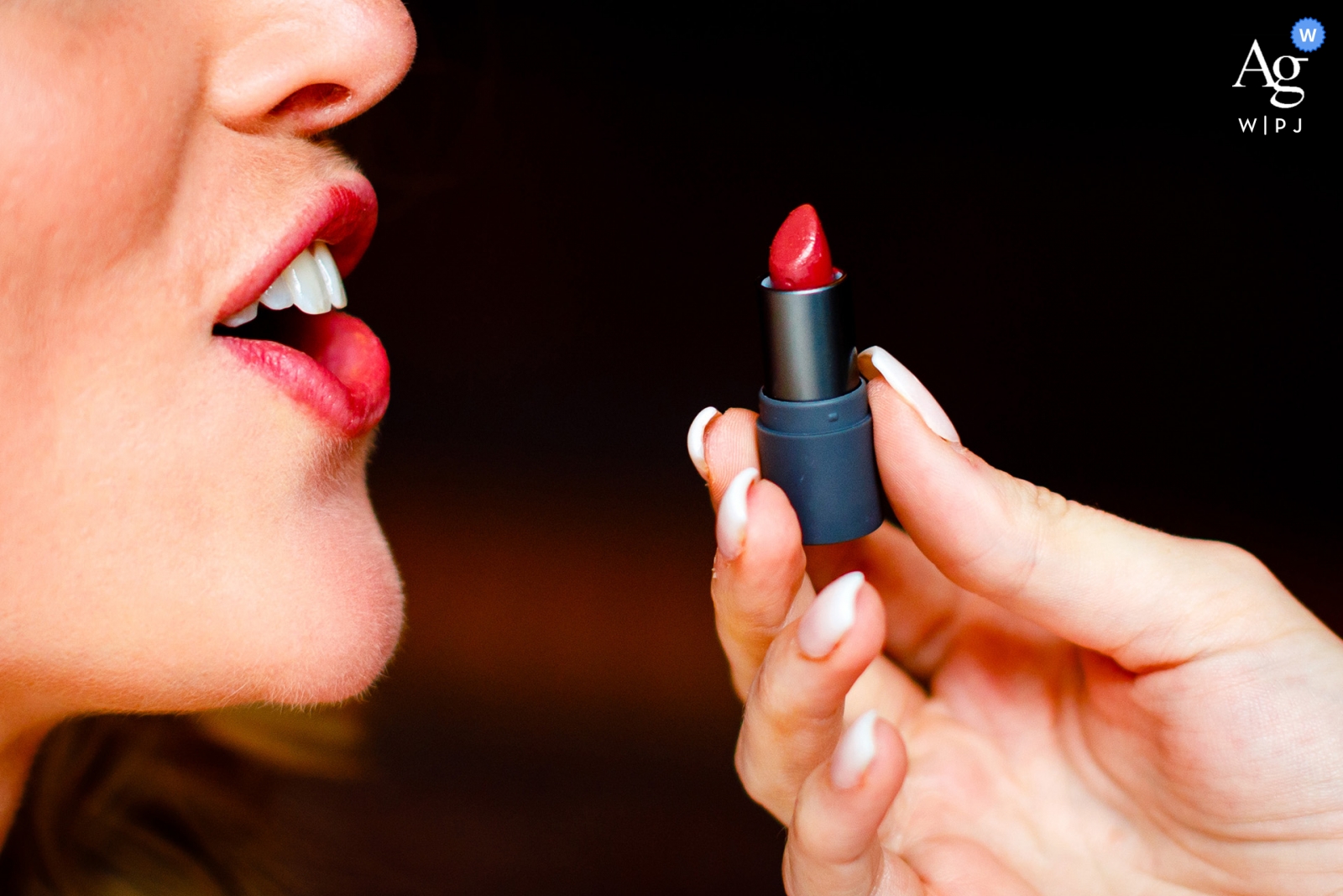 The lips of the bride being colored red at the Hotel Jerome