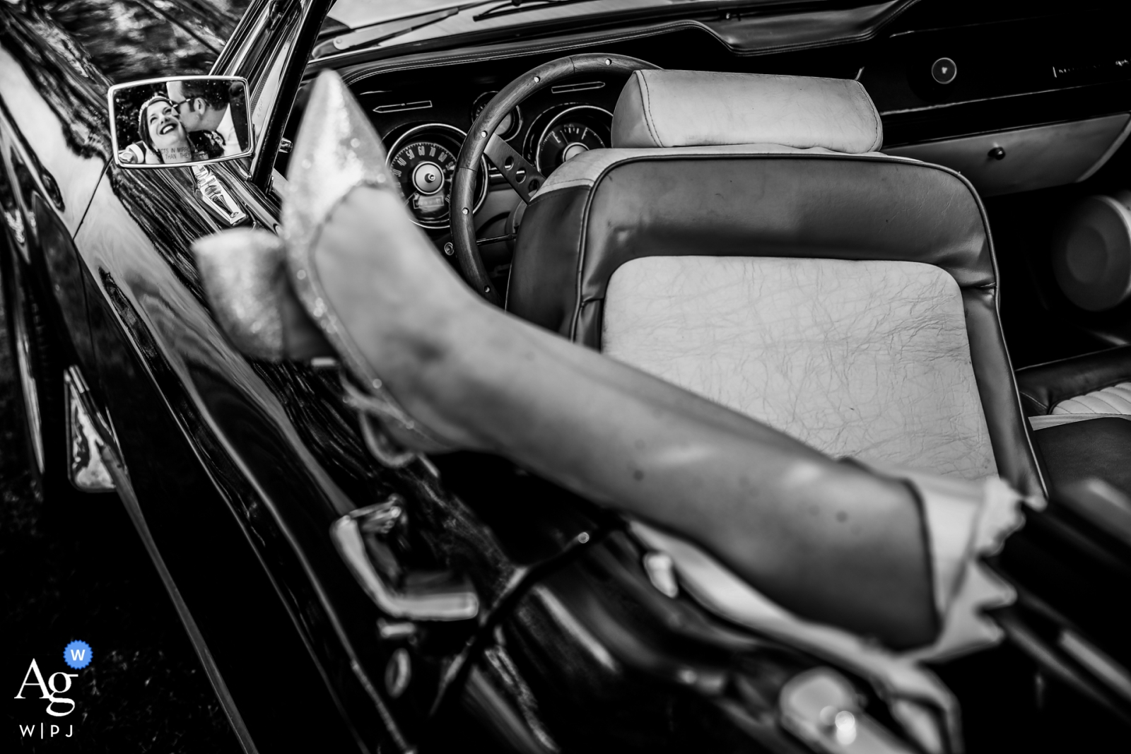 The bride and groom are reflected in the wedding car's mirror in Le Touquet, France