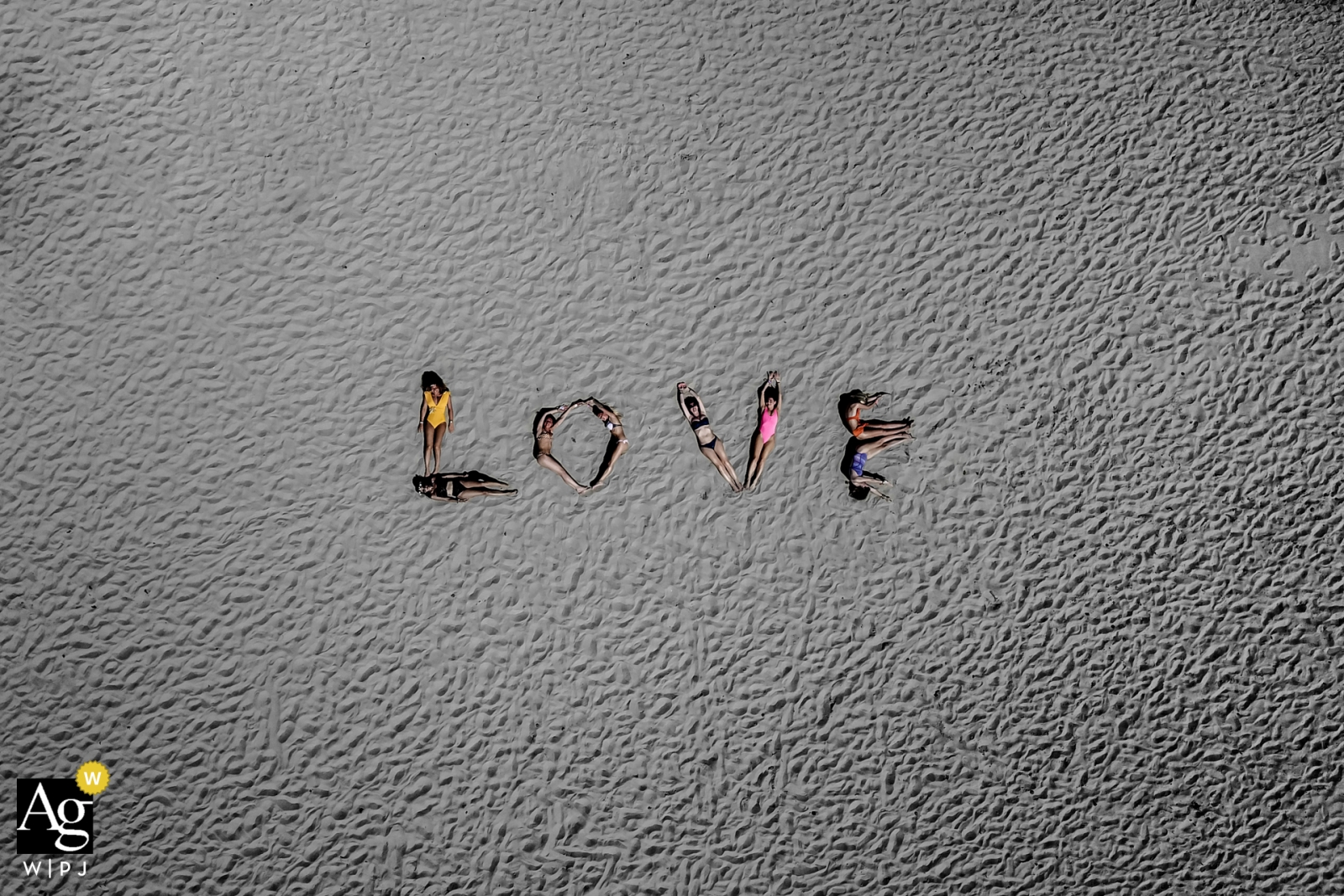 Ibiza drone beach shot of bridesmaids spelling out Love