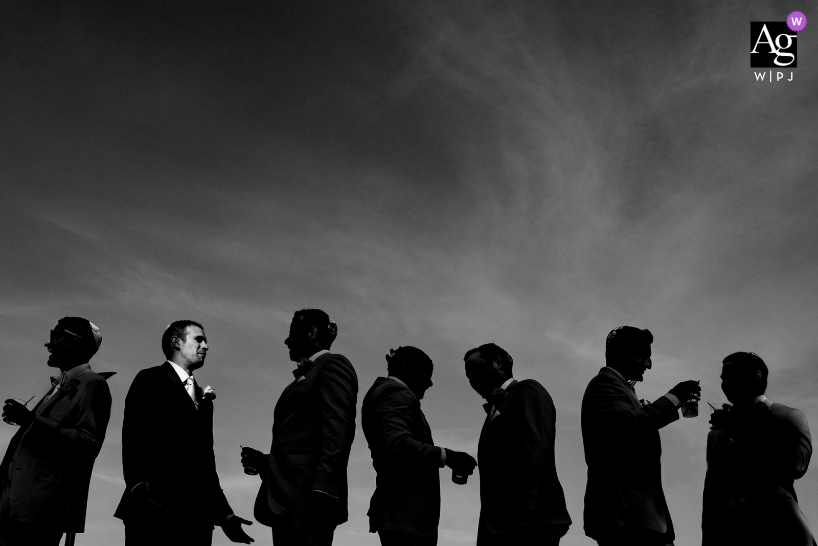 Modesto wedding portrait of the groomsmen as a silhouette and the groom's face lit