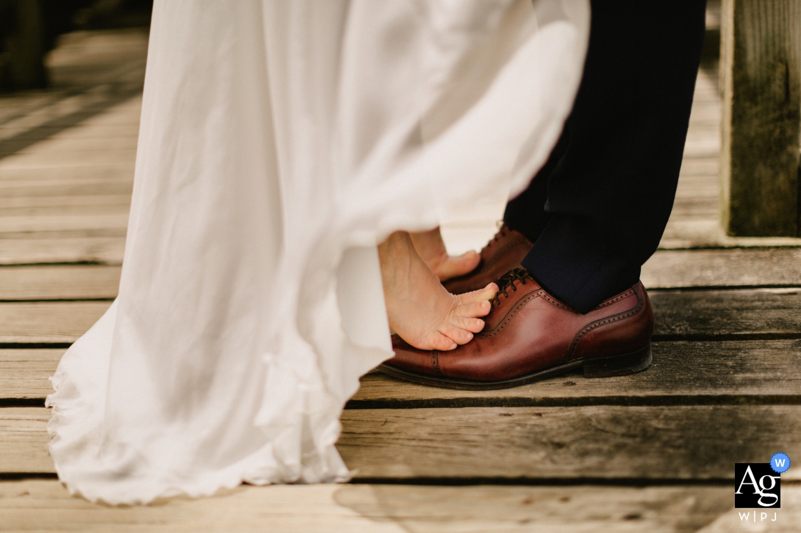 Hossegor, France wedding detail picture of the feet of the bride and groom kissing after a walk on the beach