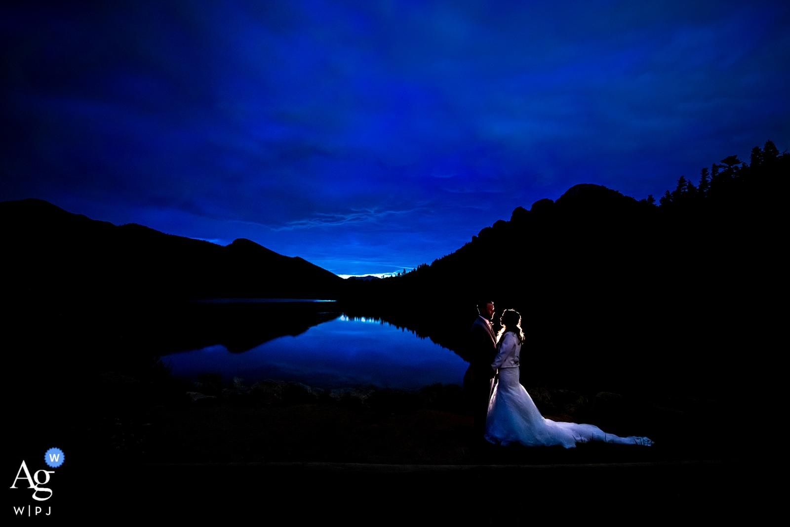 Bride and Groom blue hour portrait by lake. Lily Lake - Rocky Mountain National Park