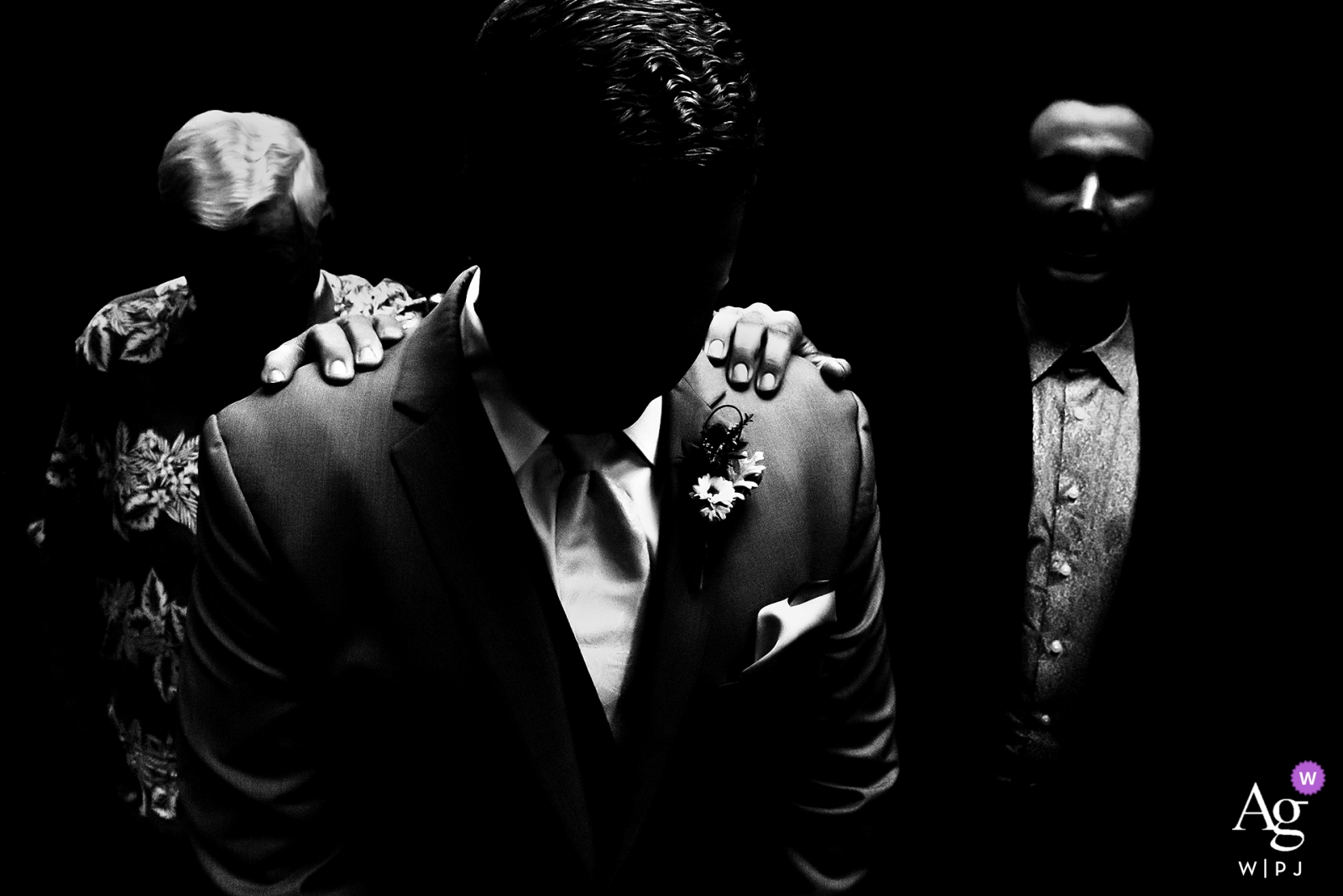 Lionsgate Event Center wedding image of the Groom praying with grandfather and officiant before ceremony