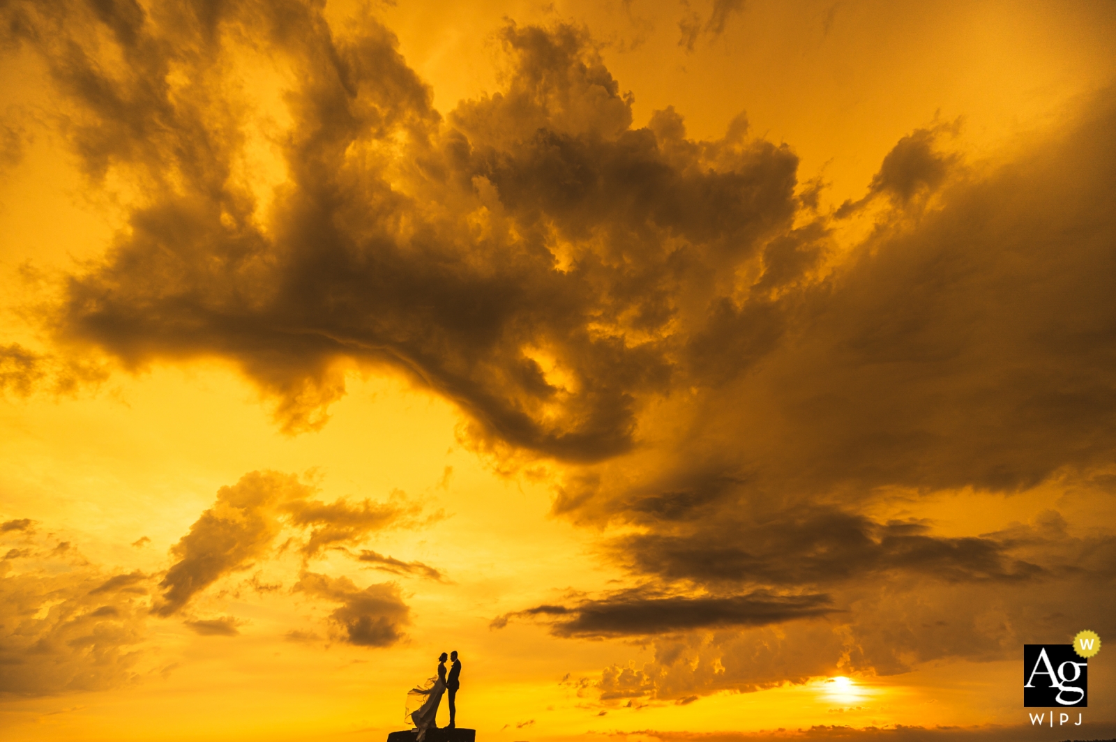 Hochzeitsbilder aus Slowenien, Auf dem Weg zum Veranstaltungsort für die Hochzeitsfeier – Bräutigam und Braut stiegen auf den Brunnen auf der Spitze des Hügels, um schöne Sonnenuntergangsfotos zu machen