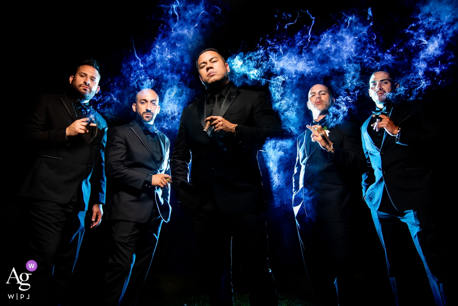 Caribbean Reception Portraits at Wedding of groom and groomsmen Caribbean Reception Portraits at Wedding - Bride & Groom's House | Photographer: 1 flash with blue gel behind subjects to pop smoke. 1 flash centered for subjects. Killed ambient light for drama.