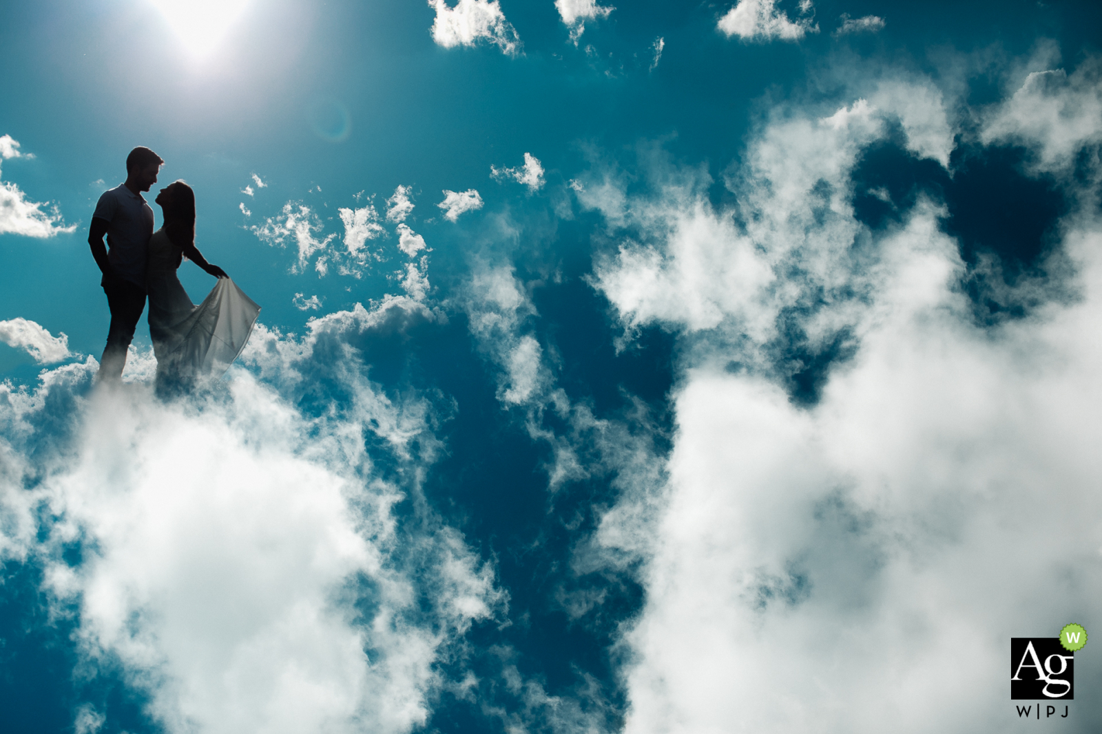 Vinícola Monte Sant'Ana - Wedding Day photo of the bride and groom up in the clouds against the blue sky