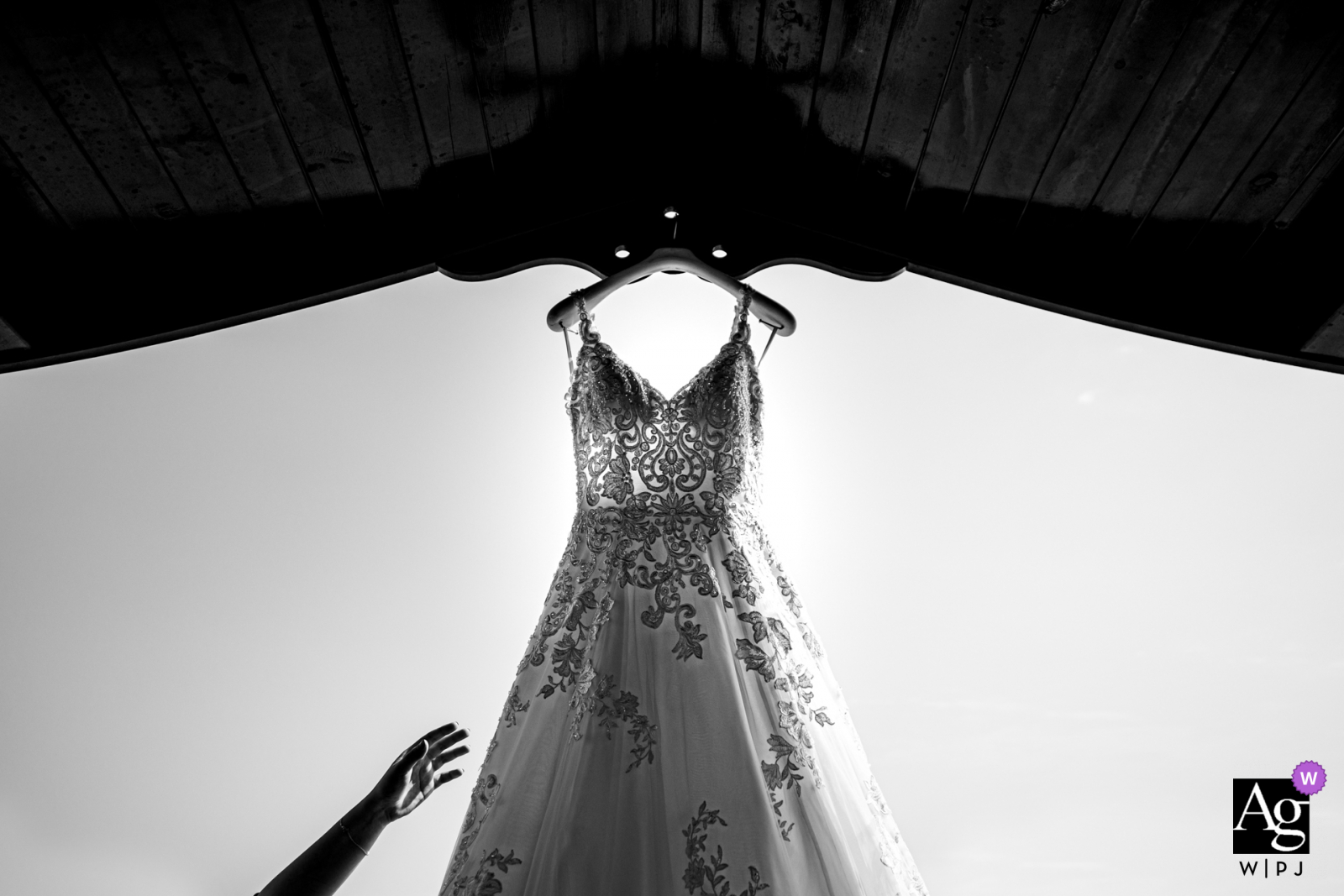 Cappadocia Demissos Cave Hotel wedding detail image of the bride trying to get her dress from a high place