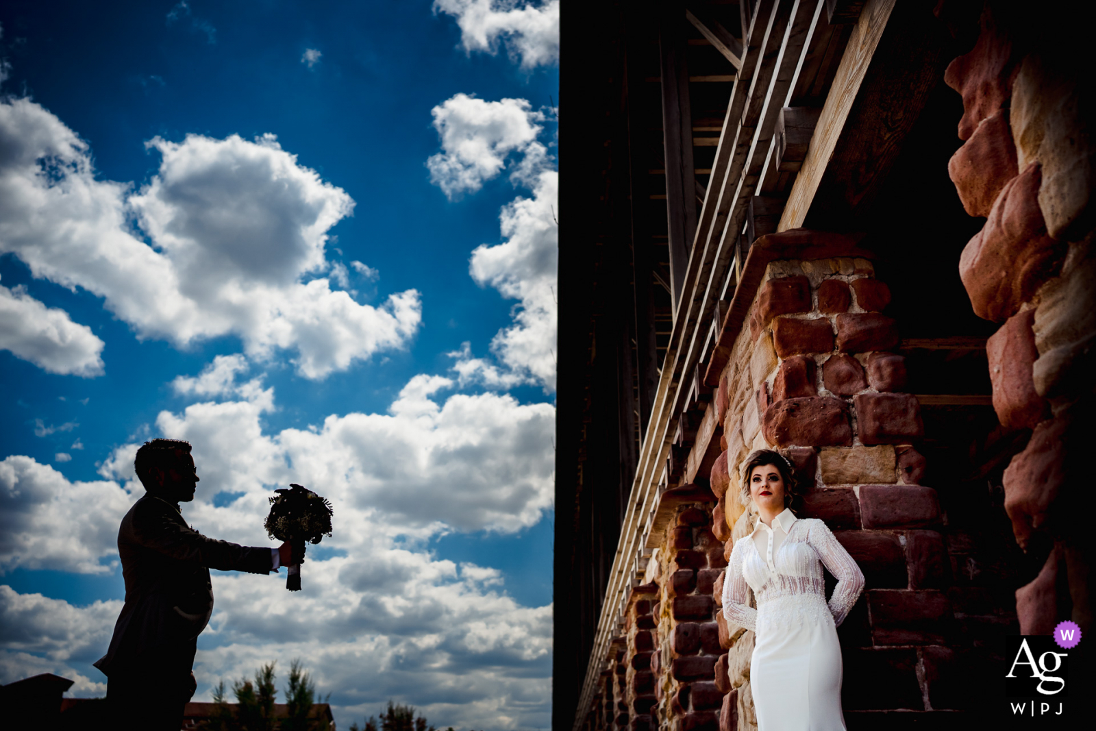 Creative portrait of the groom silhouetted holding out a bouquet of flowers and the bride in nice light against a building in Bad Dürkheim