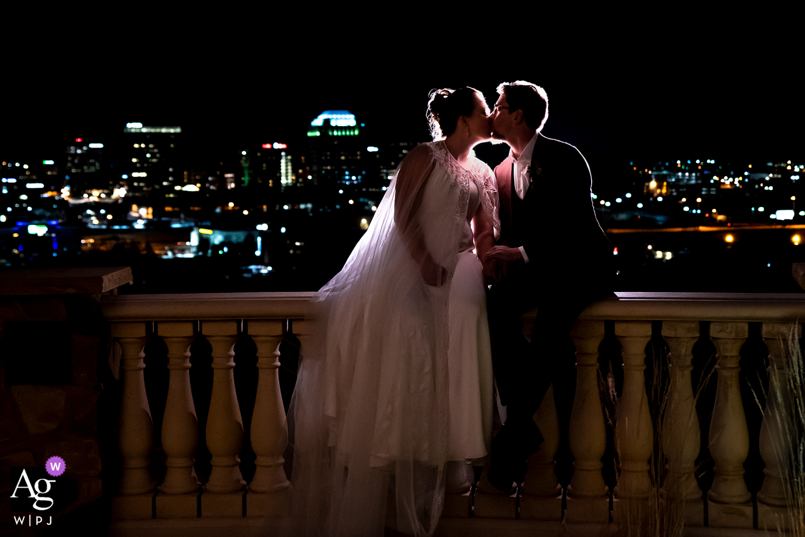 Nighttime photo of bride and groom with city skyline at Pinery at the Hill, Colorado Springs, CO