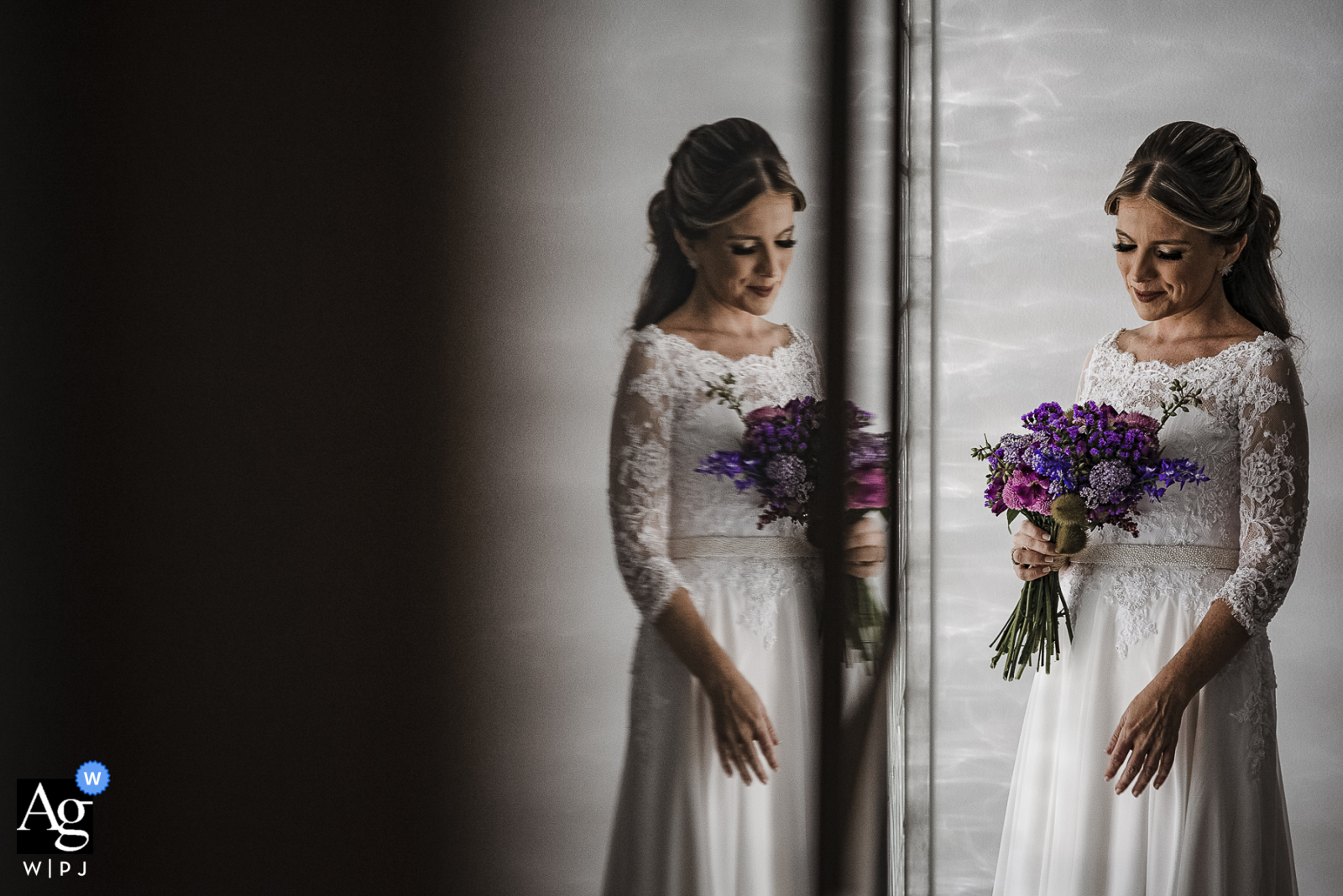 Casa da Noiva, Rio de Janeiro artistic wedding image of the bride holding her flowers and reflected in dark glass