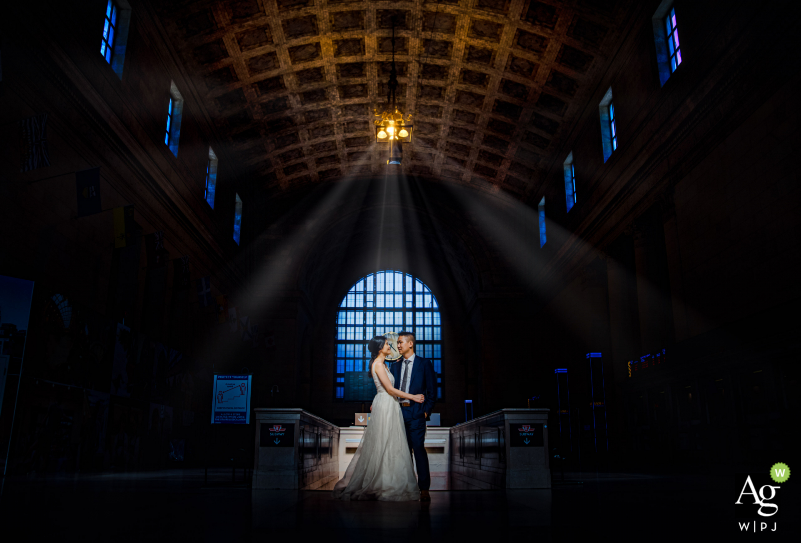 Toronto creative wedding day portrait of the couple center framed under the building Lights