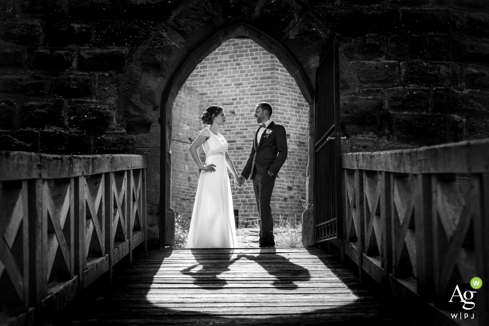 Alsace creative wedding day portrait of bride and groom at a door castle