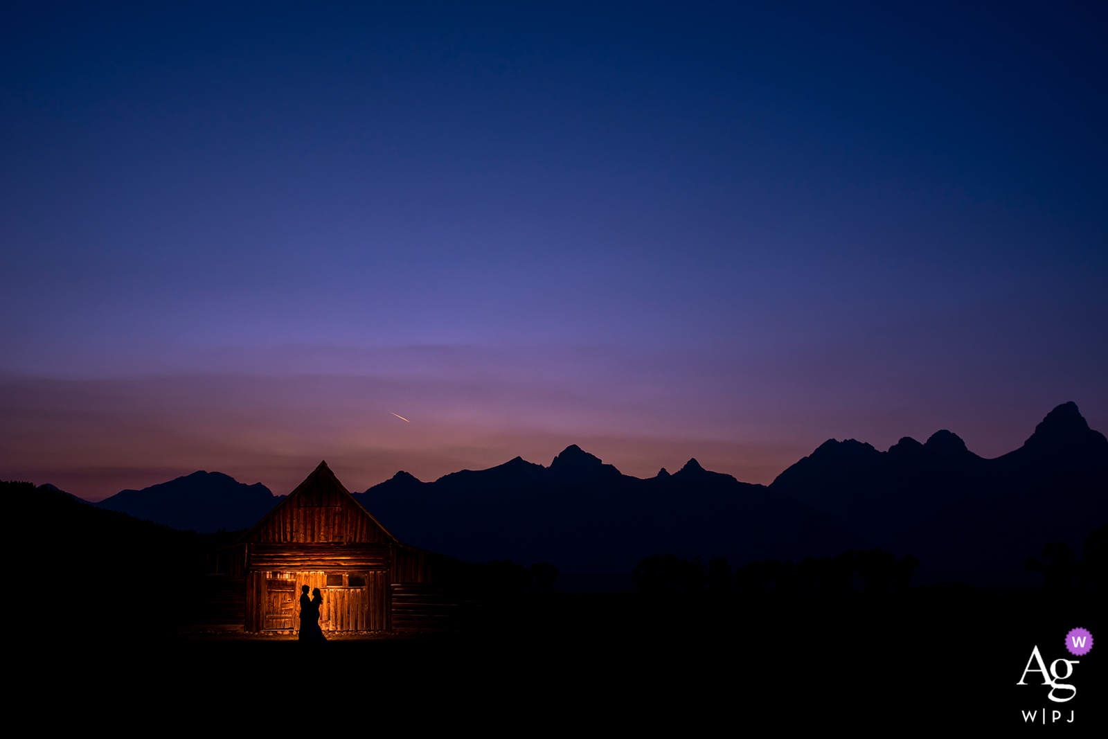 Silhouette Foto von Braut und Bräutigam gegen eine Scheune bei Sonnenuntergang am Grand Teton National Park in Jackson, WY