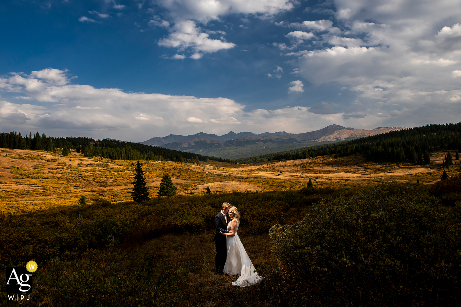portrait of bride and groom with mountain backdrop and shadows in Eagle County, Colorado portrait of bride and groom with mountain backdrop and shadows in Eagle County, Colorado
