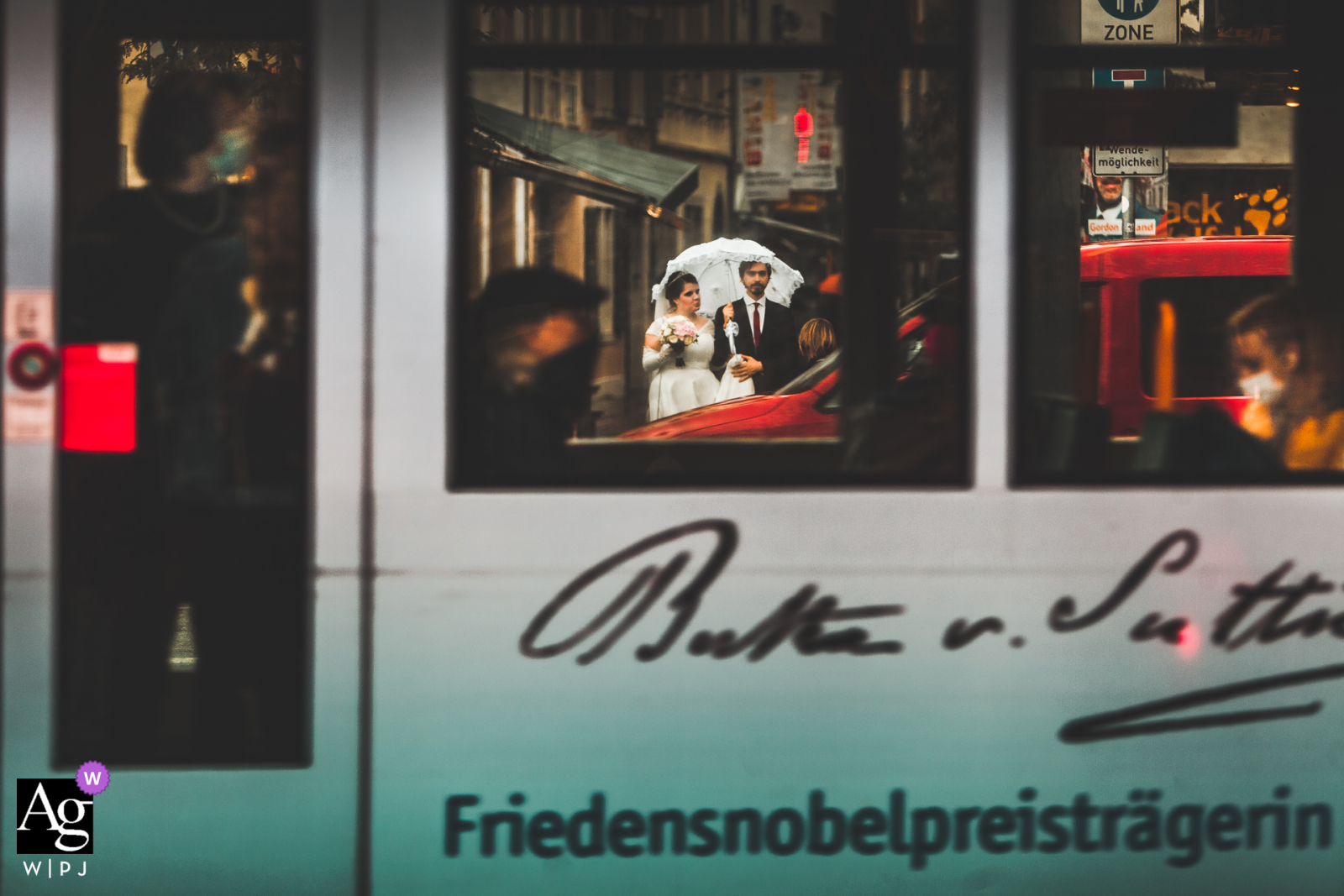 Bonn, Germany Couple at a pedestrian crossing during an urban wedding day portrait session in the rain with an umbrella Bonn. Germany Couple at a pedestrian crossing during an urban wedding day portrait session in the rain with an umbrella