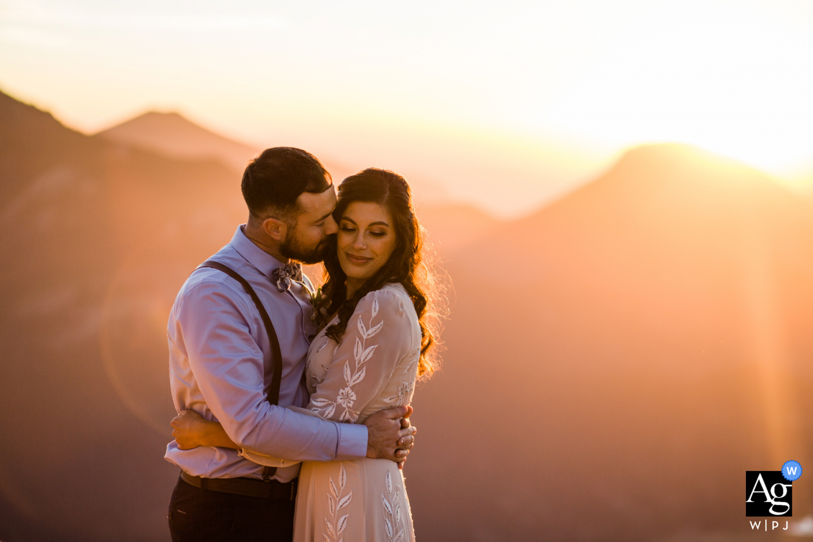 Rocky Mountain National Park wedding portrait of the groom kissing bride's cheek during this sunset session