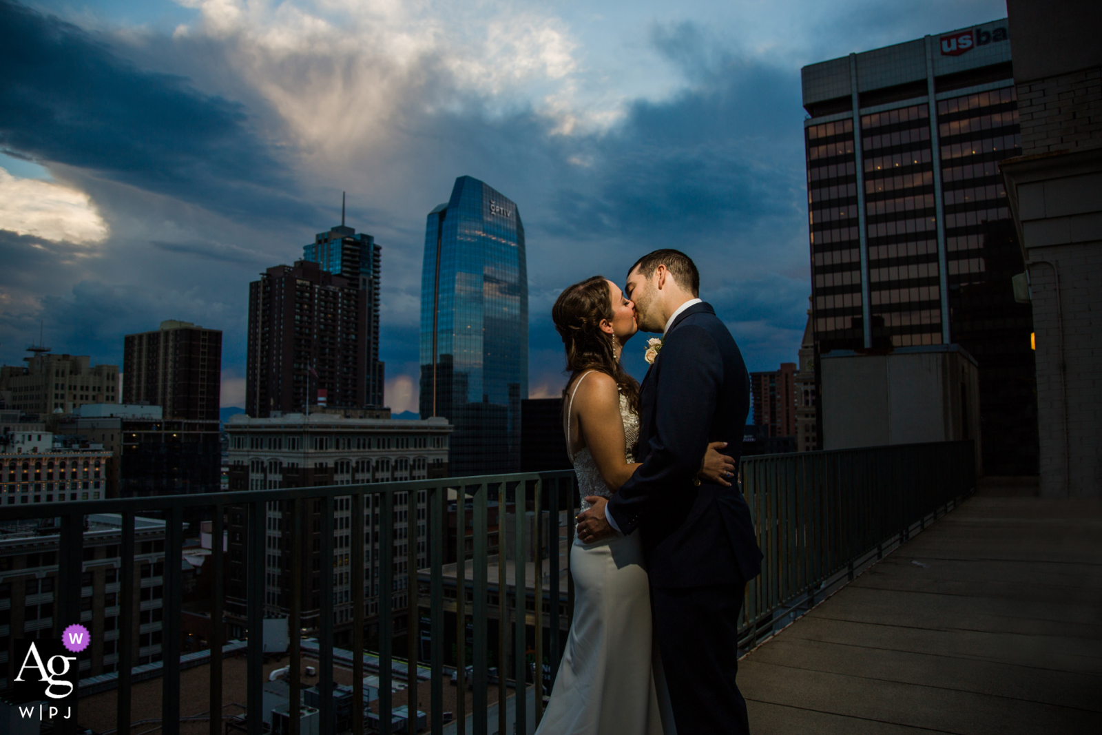 Colorado couple kissing at sunset at top of the Magnolia Hotel in Denver