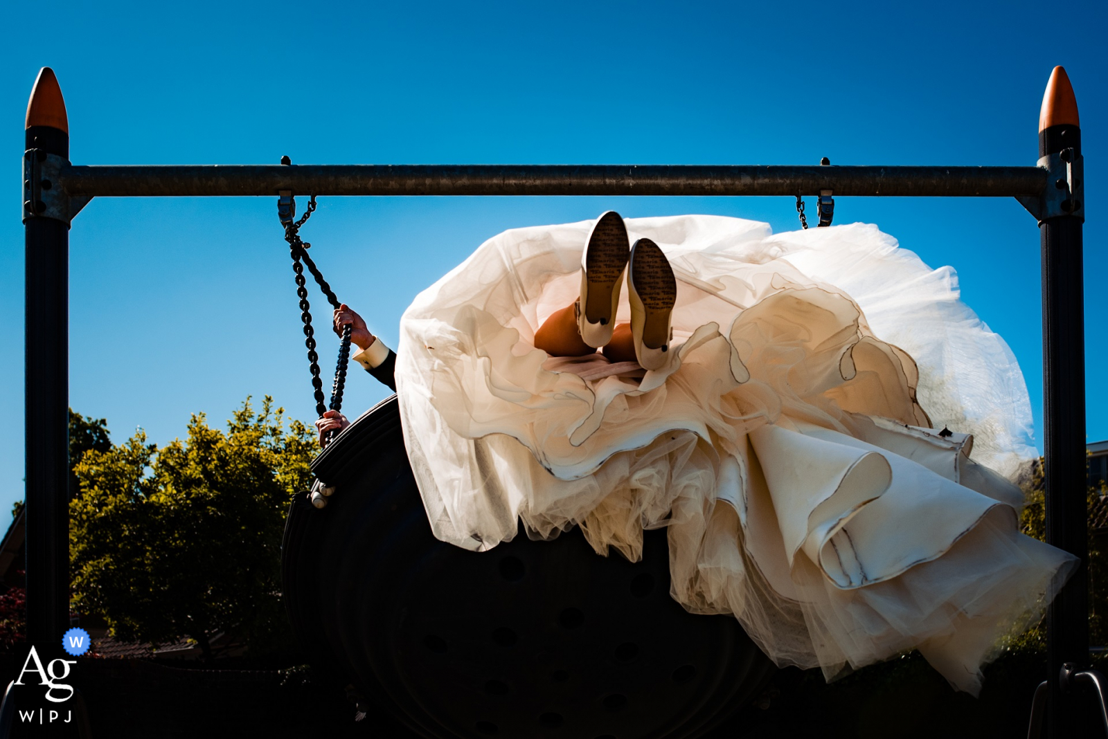 Heusden City artistic wedding Swing along photo against a blue sky Heusden City artistic wedding Swing along photo against a blue sky