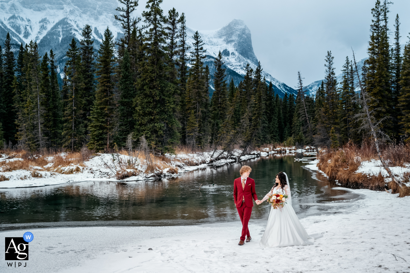 Canmore, AB, Canada creative wedding day portrait of the Bride and groom holding the hands after the ceremony 