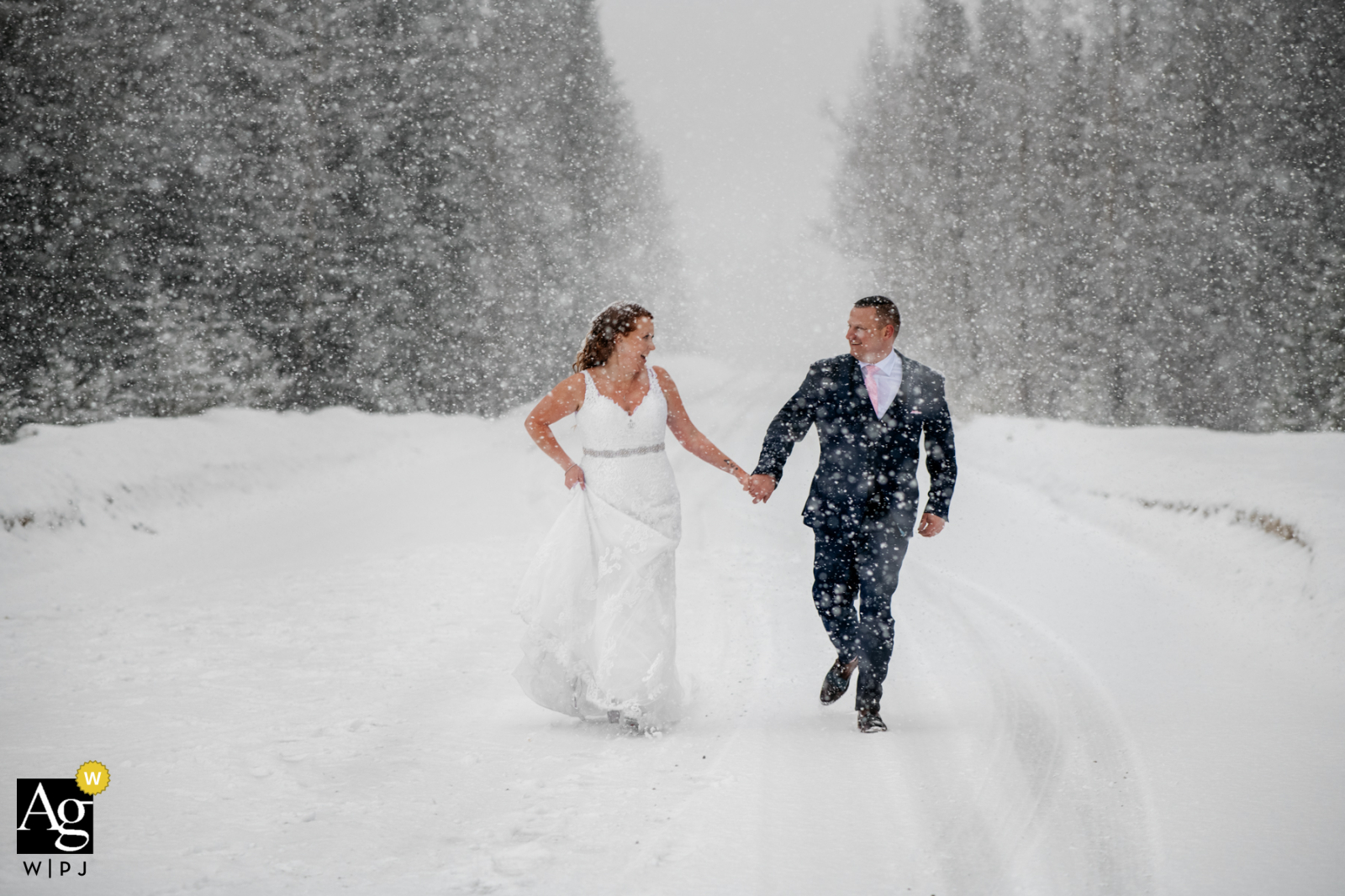 Natural Bridge, Field, BC, Canada creative couple wedding portrait of the Bride and groom having fun during the snowfall Natural Bridge, Field, BC, Canada creative couple wedding portrait of the Bride and groom having fun during the snowfall