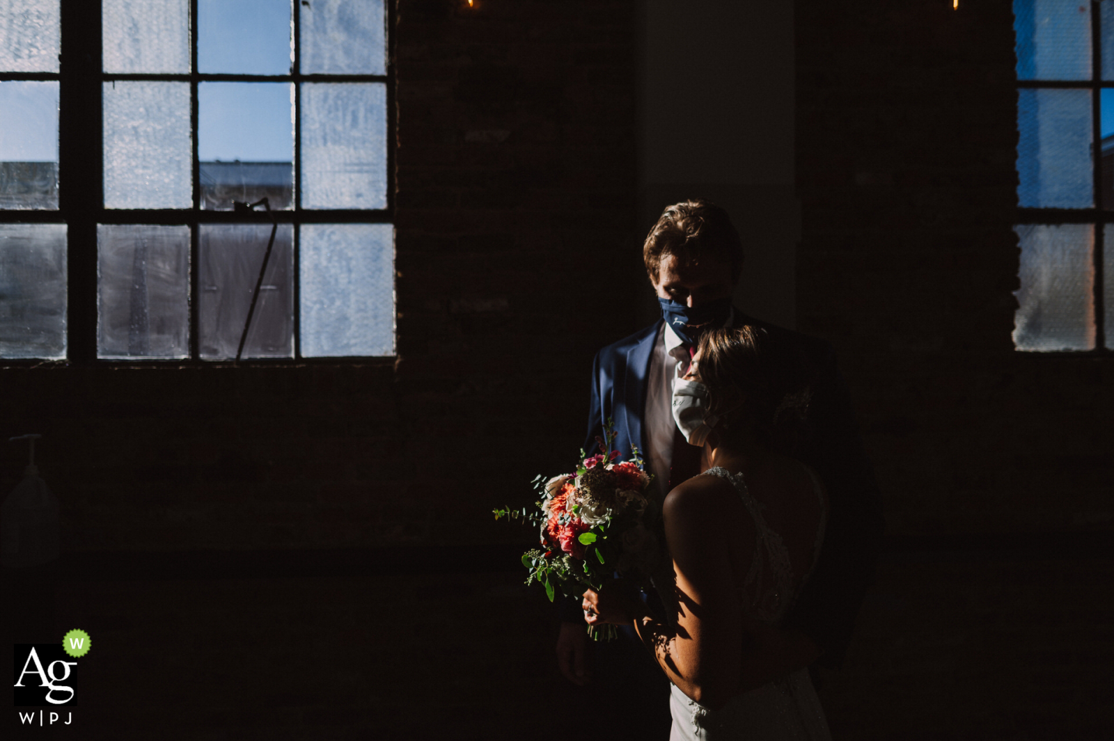 Fredericksburg, MD wedding couple posed portrait session catching some breath through the rustic window after the ceremony. 