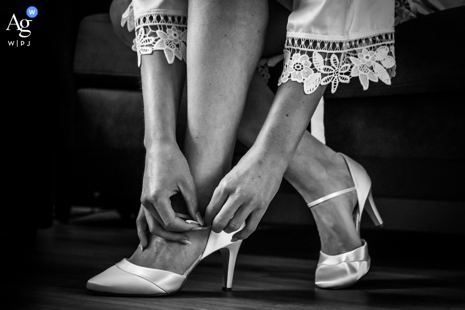 View this ornamental Netherlands wedding image in BW of The bride putting her shoes on, which was a featured picture among the best wedding photography from the WPJA