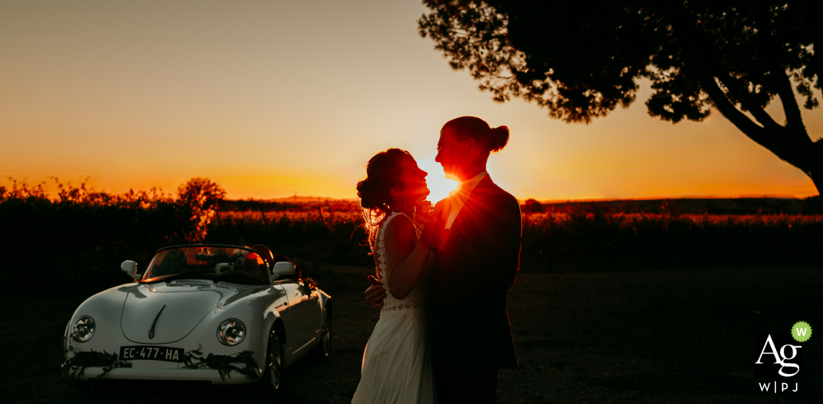 Bathed in the golden light of sunset, the bride and groom posed with a vintage convertible Porsche during their romantic couple's session at Domaine de la Clausade Mauguio.