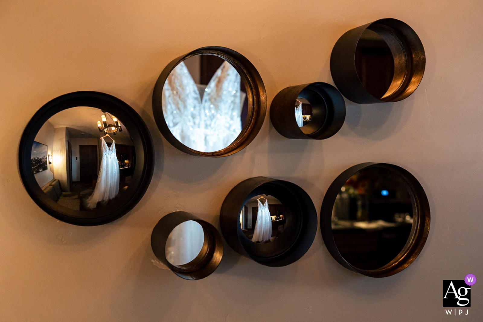 Luxurious Reflections: Bride's Dress in Chandelier and Mirrors, Denver A WPJA photographer captures the intricate details of the bride's dress elegantly reflecting in the chandelier and mirrors, adding a touch of luxury in Denver, Colorado.