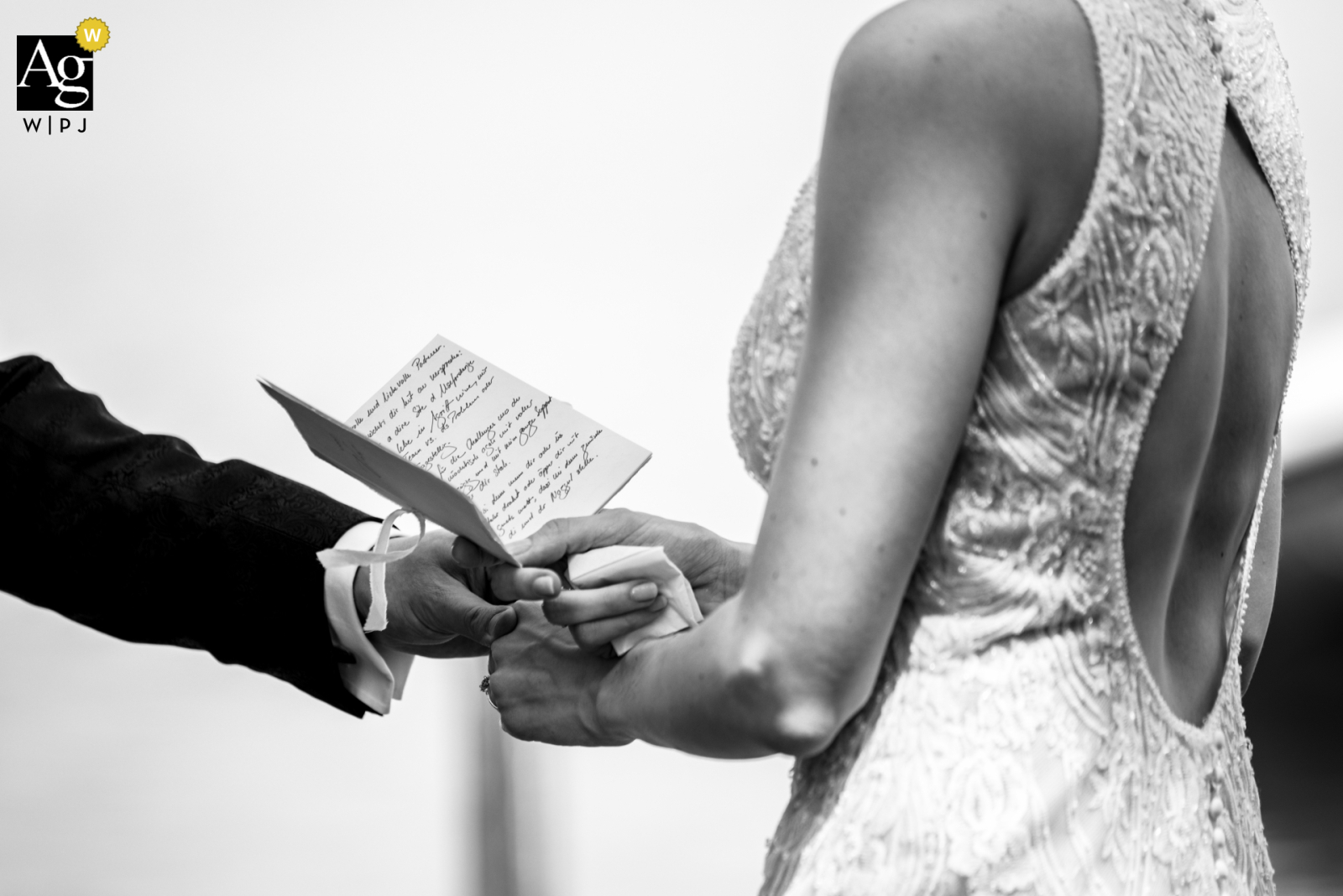 Discover a touching image captured in black and white in Zug, Switzerland. See the bride's heartfelt vows come to life as she holds her notes in this artistic wedding photo.