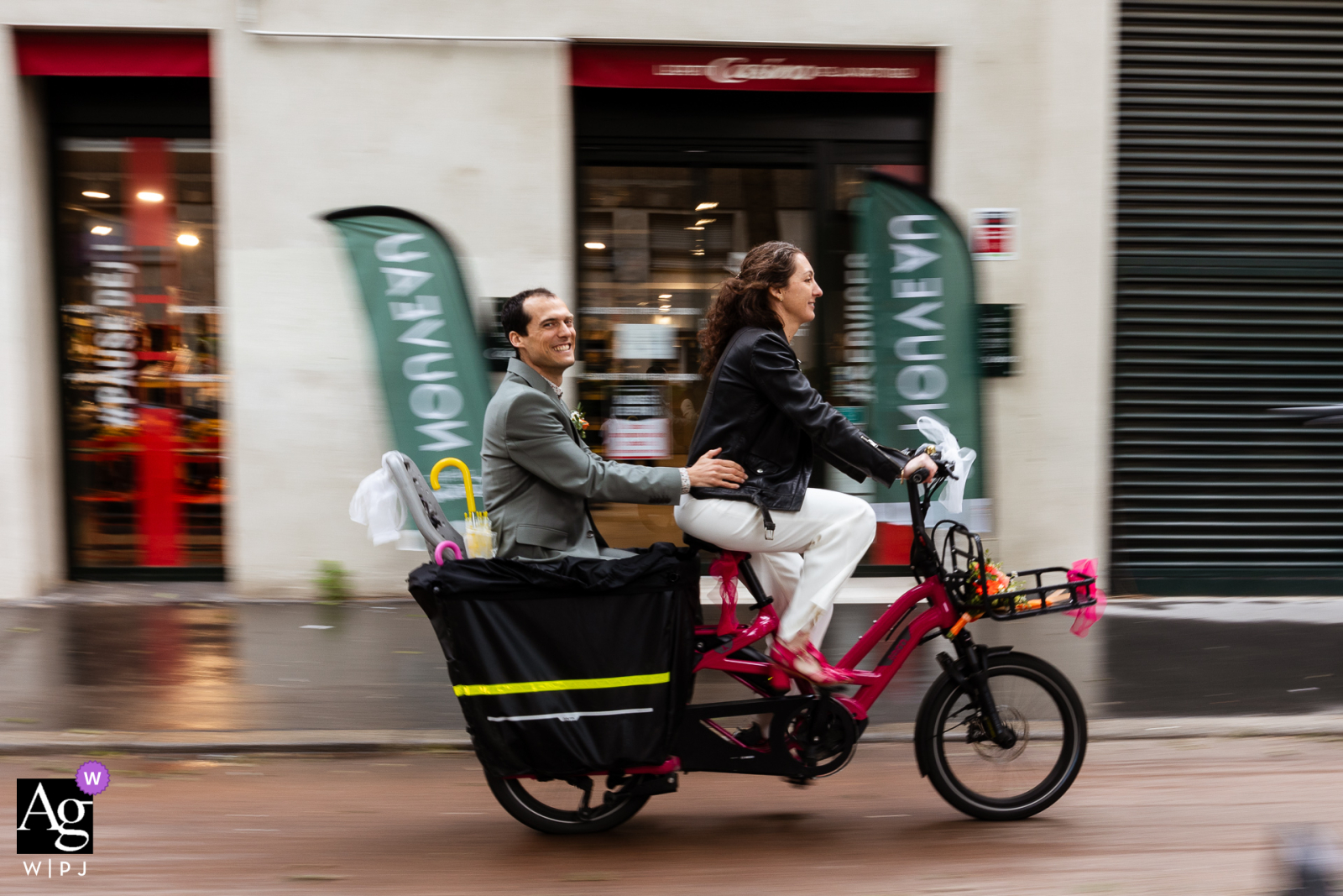 In the streets of Paris, the bride and groom ride together, joyfully traveling to their venue after the ceremony, surrounded by the city's iconic charm and romantic ambiance.