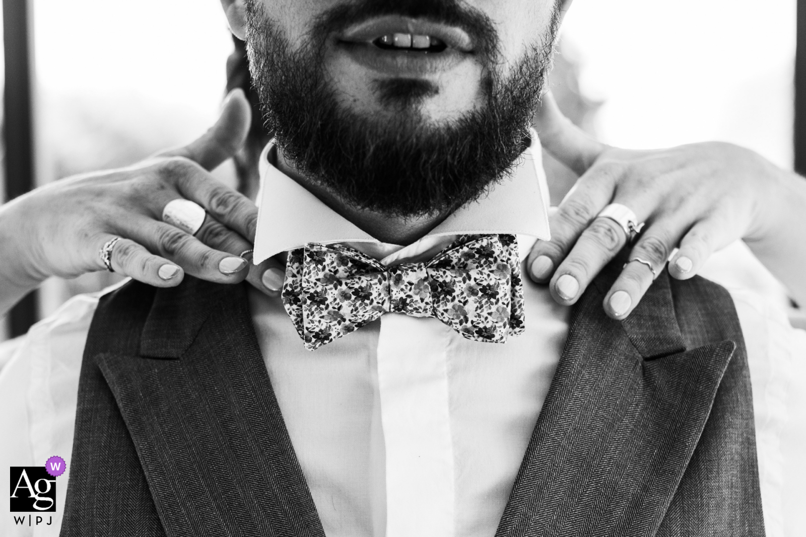At the Vienne wedding venue, the groom is seen receiving help with his tie in a moment that captures the final touches before heading to the ceremony, highlighting the preparation and anticipation of the day. 
